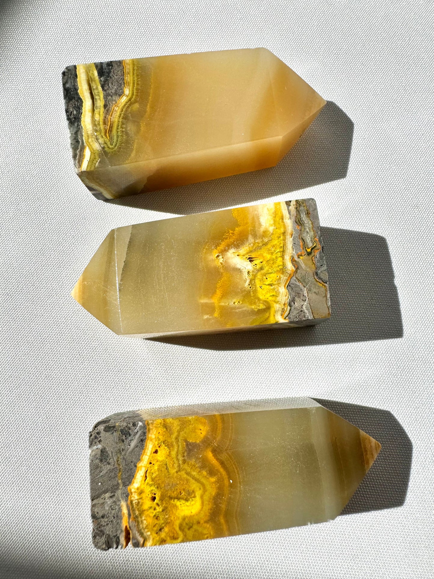 Bumblebee Jasper Crystal Tower | Bespoke Crystals shown in a horizontal layout, highlighting vivid yellow, grey, and orange mineral layers.