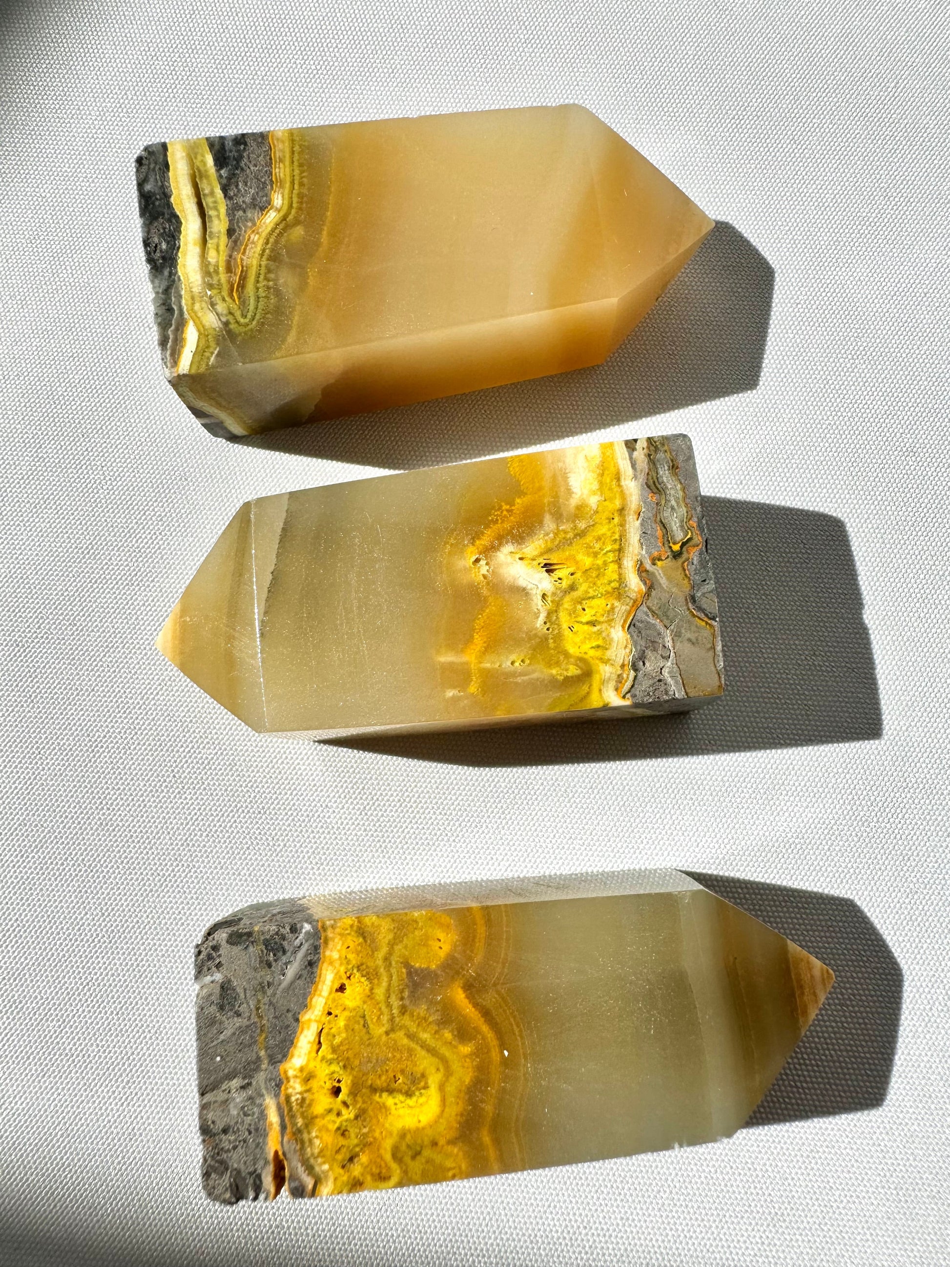 Bumblebee Jasper Crystal Tower | Bespoke Crystals shown in a horizontal layout, highlighting vivid yellow, grey, and orange mineral layers.