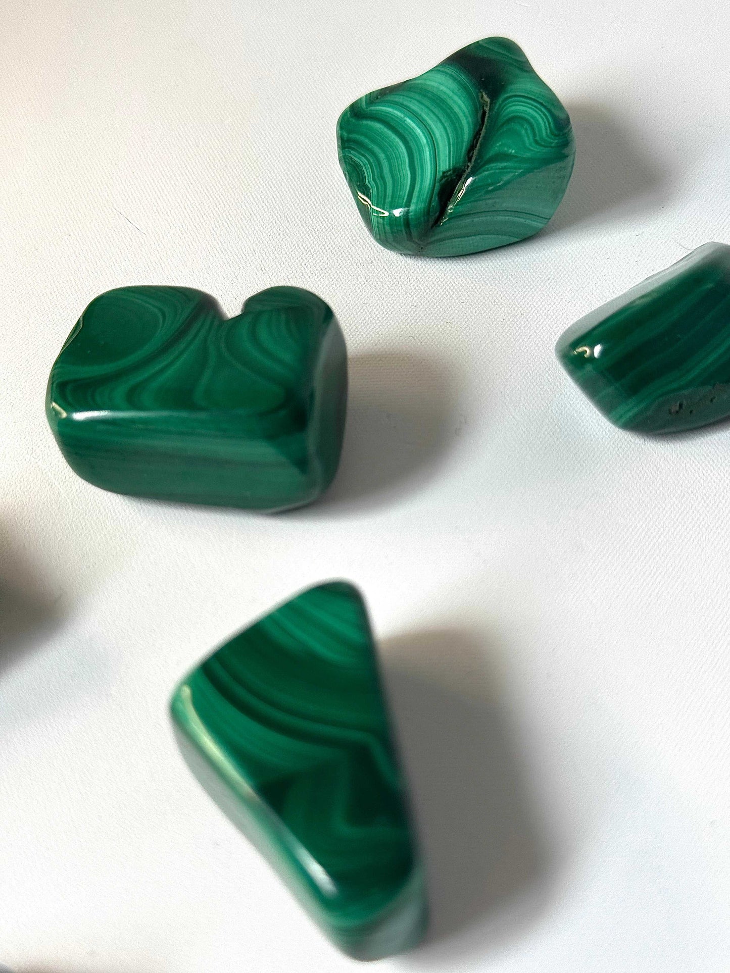 Malachite Tumble Stones showcasing smooth finish and vibrant green swirls, perfect for emotional balance and meditation | Bespoke Crystals