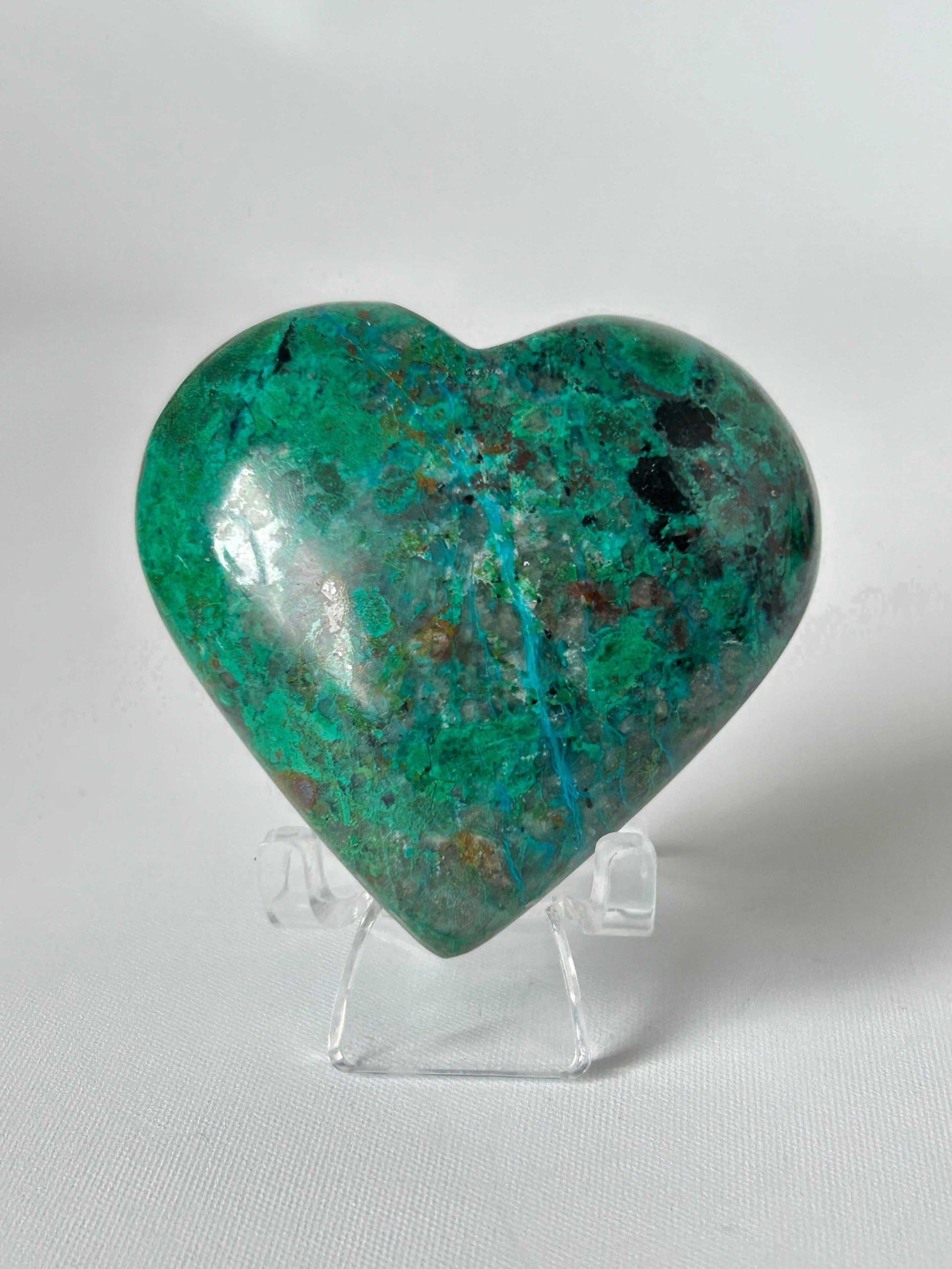 Malacolla Crystal Heart #3 with vibrant green and turquoise hues on a clear stand, from the Bespoke Crystals collection