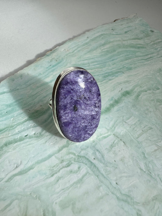 Large Charoite Crystal Ring with oval purple gemstone set in sterling silver, showcasing lavender and violet swirls. Ideal for spiritual jewelry lovers.