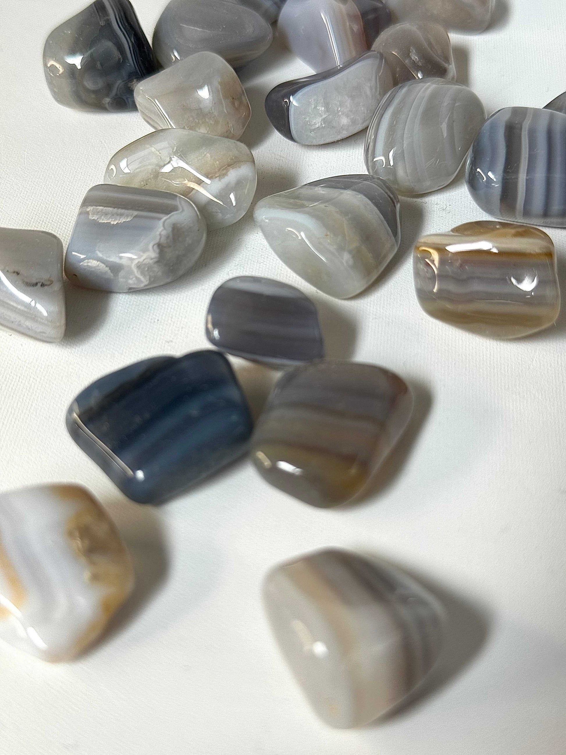 Close-up of Banded Agate Crystal Tumble Stones showcasing natural banding, used for grounding and emotional balance.