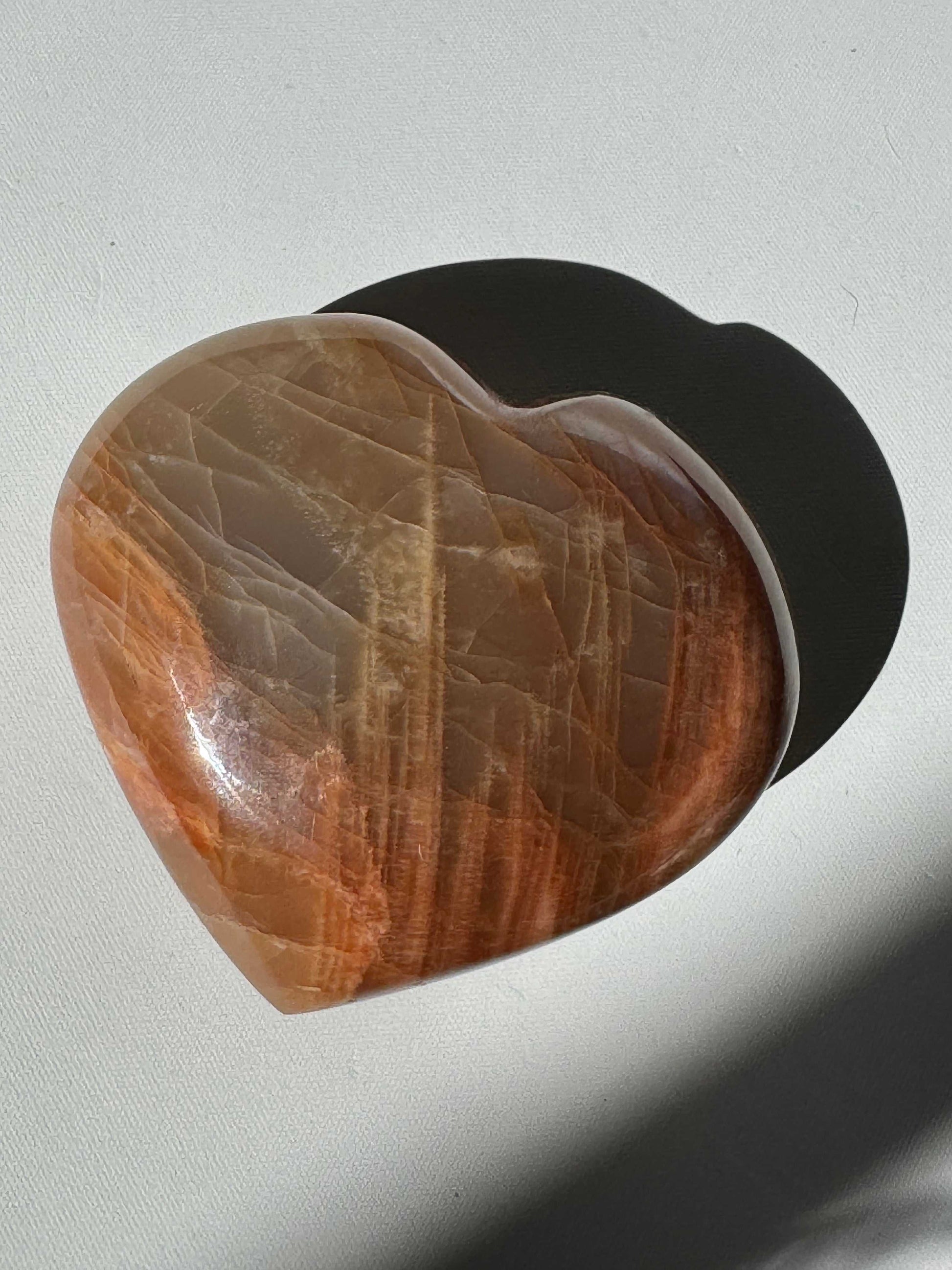 Polished Peach Moonstone Heart #1 with warm orange and beige tones, ideal for collectors of carved gemstone hearts and metaphysical decor | Crystals NZ