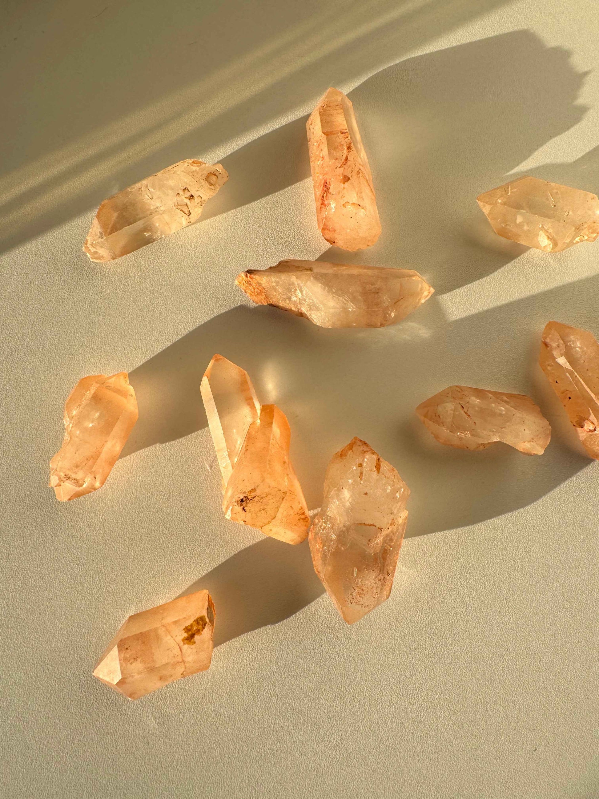 Lemurian Tangerine Crystal Quartz | Bespoke Crystals displayed in natural light, showcasing their orange hue and clarity, ideal for collectors.