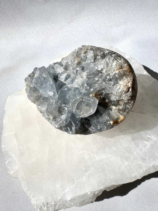 Celestite Cluster #5 crystal druze with translucent blue points on a white stone base, ideal for peace, connection, and wisdom in crystal collections.