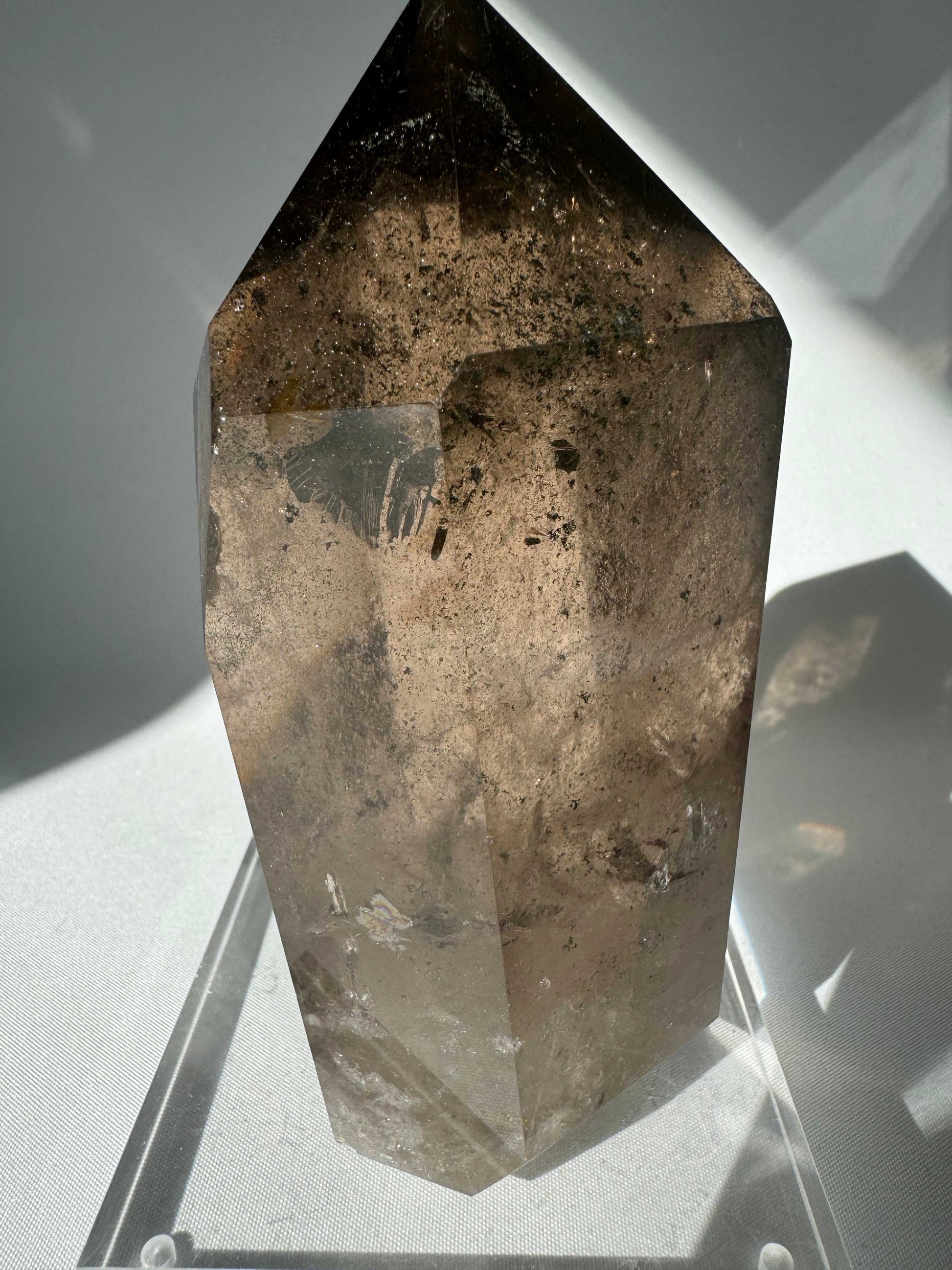 Large Smokey Quartz Crystal Point with phantom inclusions and rainbows, ideal for grounding and protection in bespoke crystal collections.