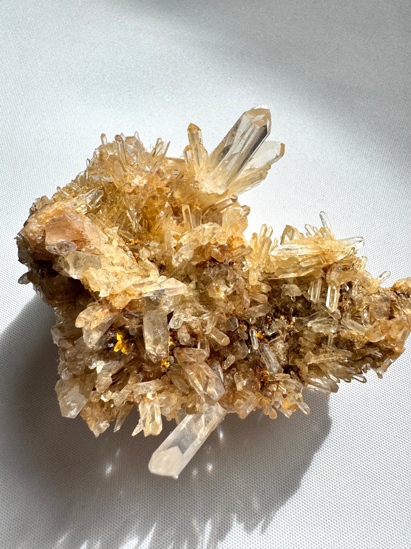 Detailed view of Blue Smoke Halloysite-Included Lemurian Crystal Cluster showcasing translucent quartz points and earthy mineral inclusions.