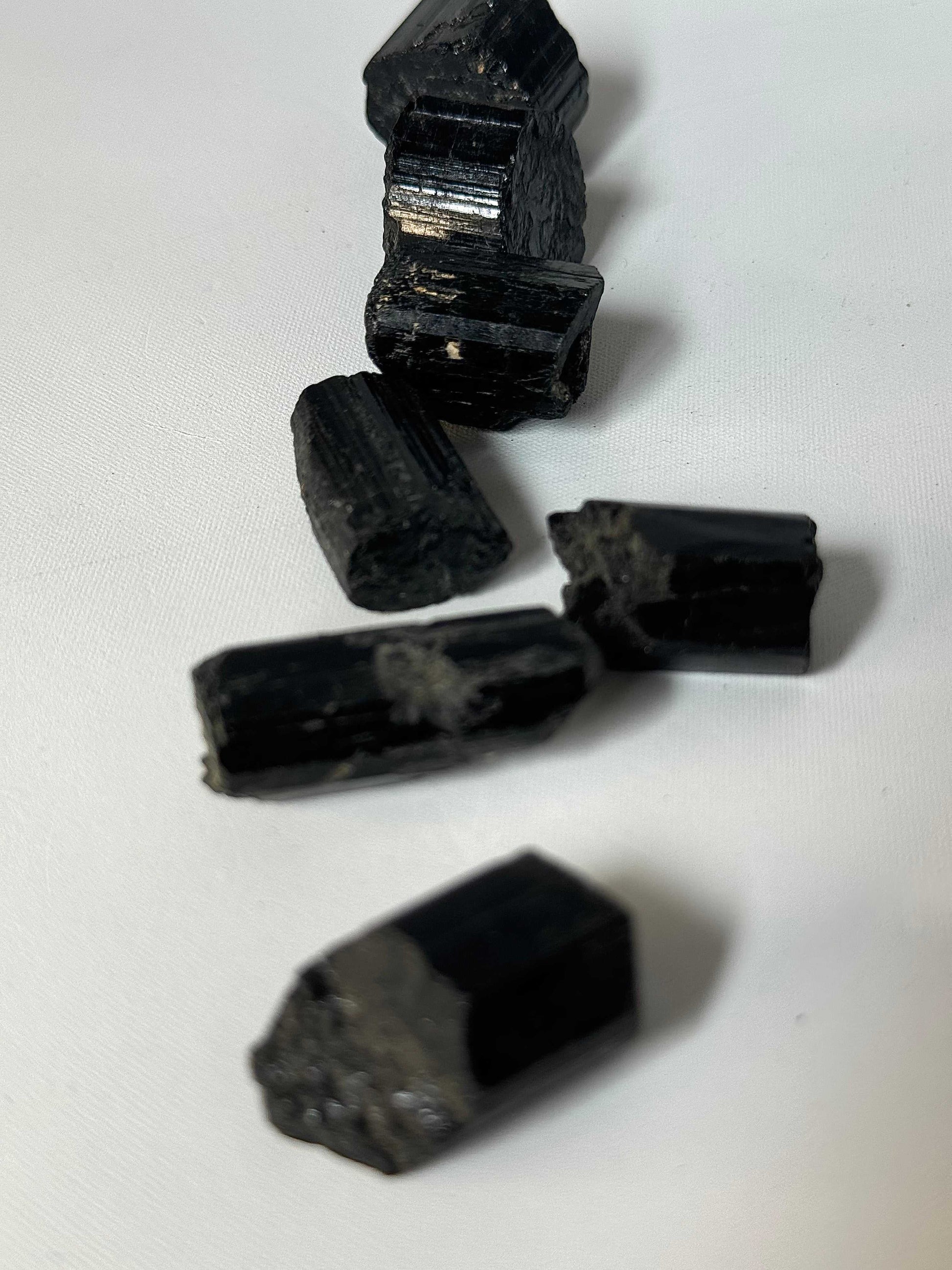 Close-up of Black Tourmaline Crystal Raw Pieces | Bespoke Crystals highlighting their unpolished, earthy form for collectors and crystal enthusiasts.