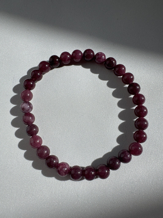 Garnet Crystal 6mm Bracelet | Bespoke Crystals featuring deep red polished beads, ideal for healing and confidence, displayed on white fabric.