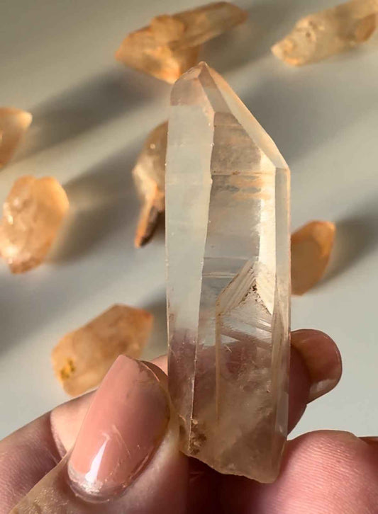 Close-up of a Lemurian Tangerine Crystal Quartz | Bespoke Crystals with visible striations and iron inclusions, perfect for metaphysical use or display.