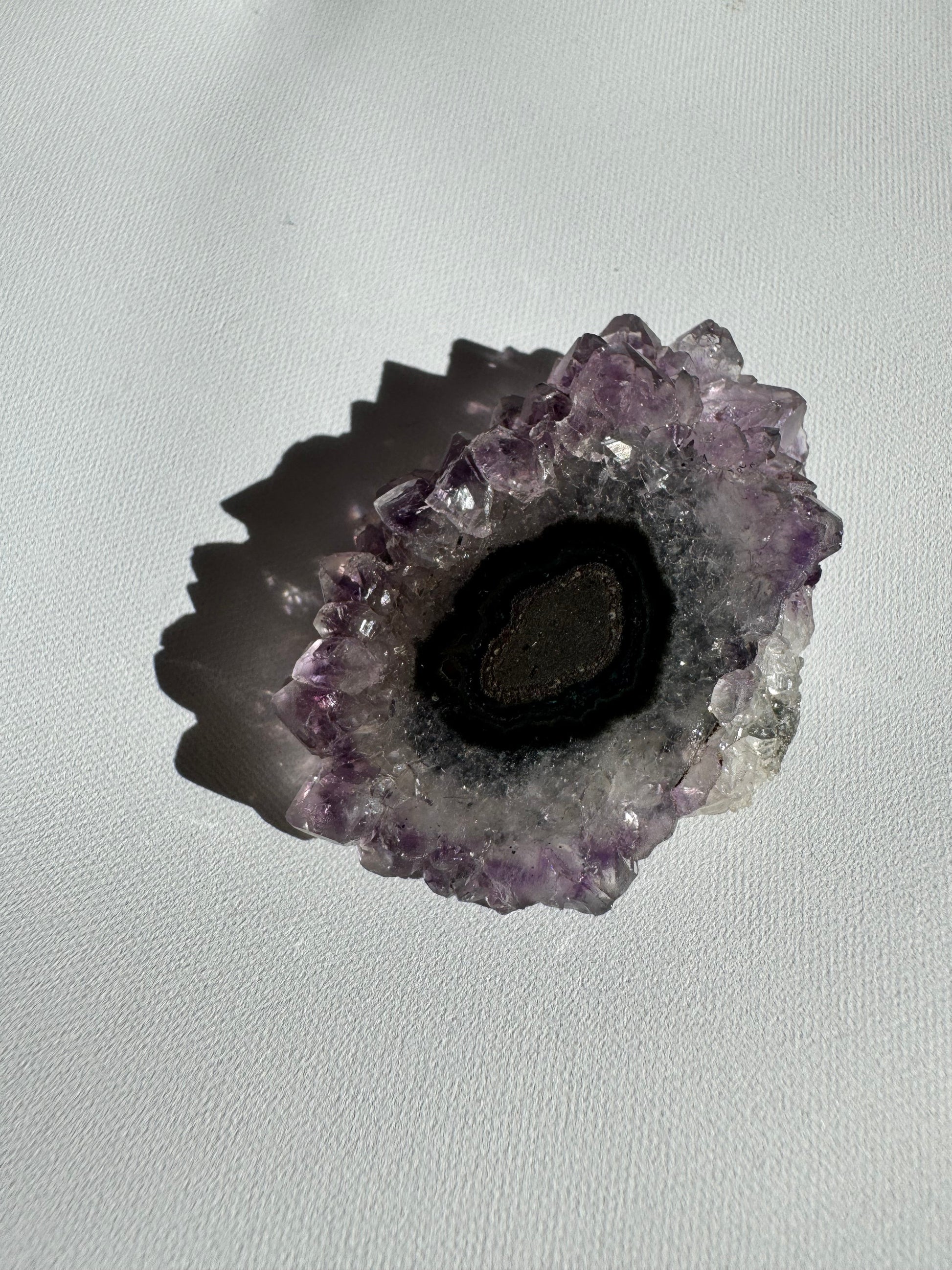 Dark-centered Amethyst Crystal Stalactite Grade A with black and grey concentric layers, ideal for rock and crystal collections.
