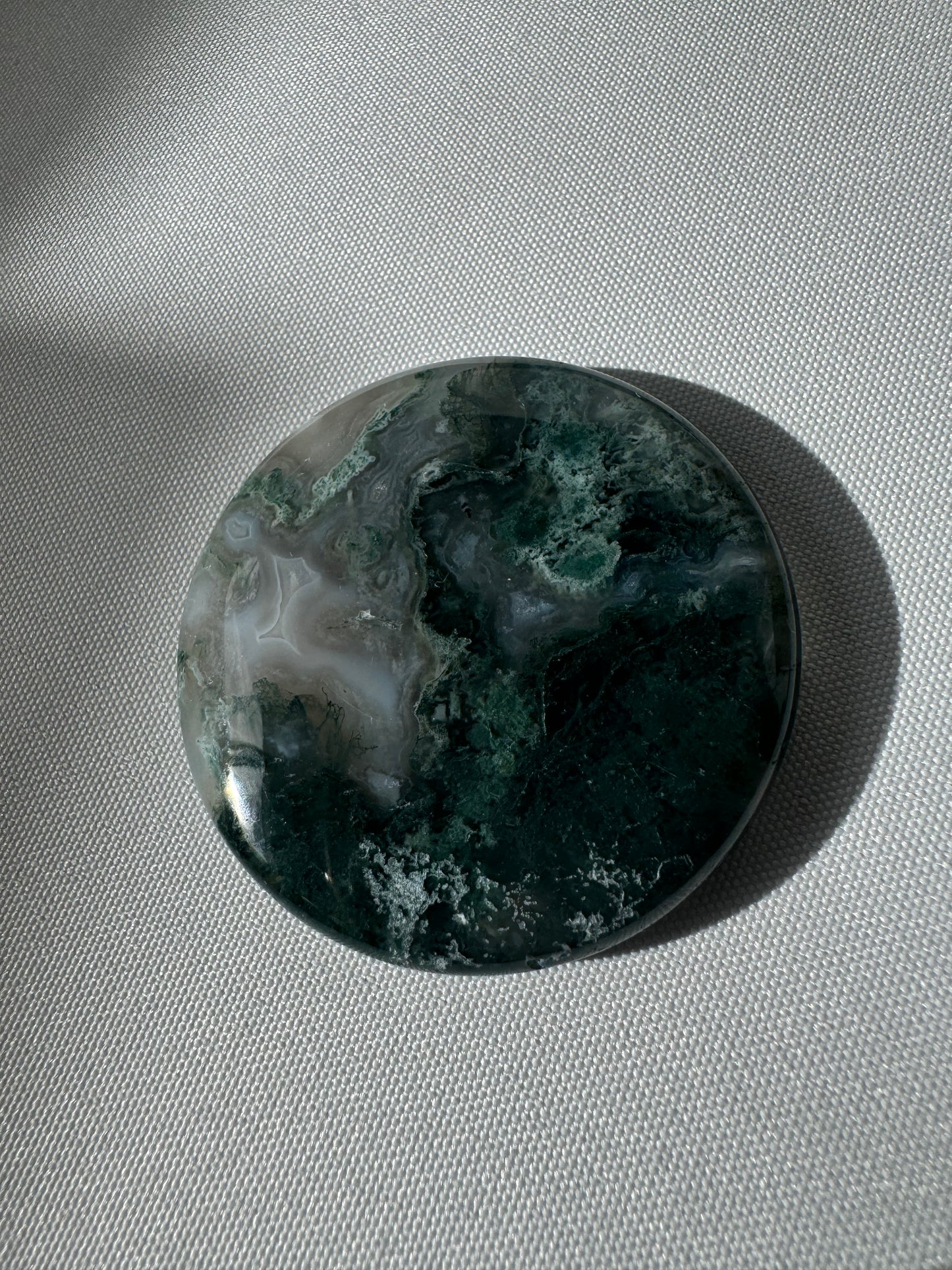 Single Moss Agate Crystal Coin | Bespoke Crystals featuring deep green swirls and translucent patterns, ideal for collectors and crystal enthusiasts.