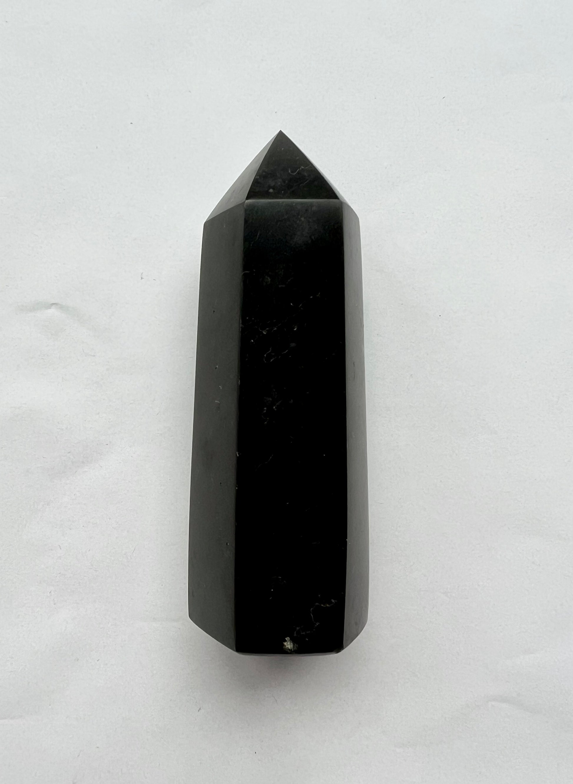 Top view of Black Tourmaline Crystal Tower showcasing its smooth, faceted surface; perfect for spiritual cleansing and energy shielding.