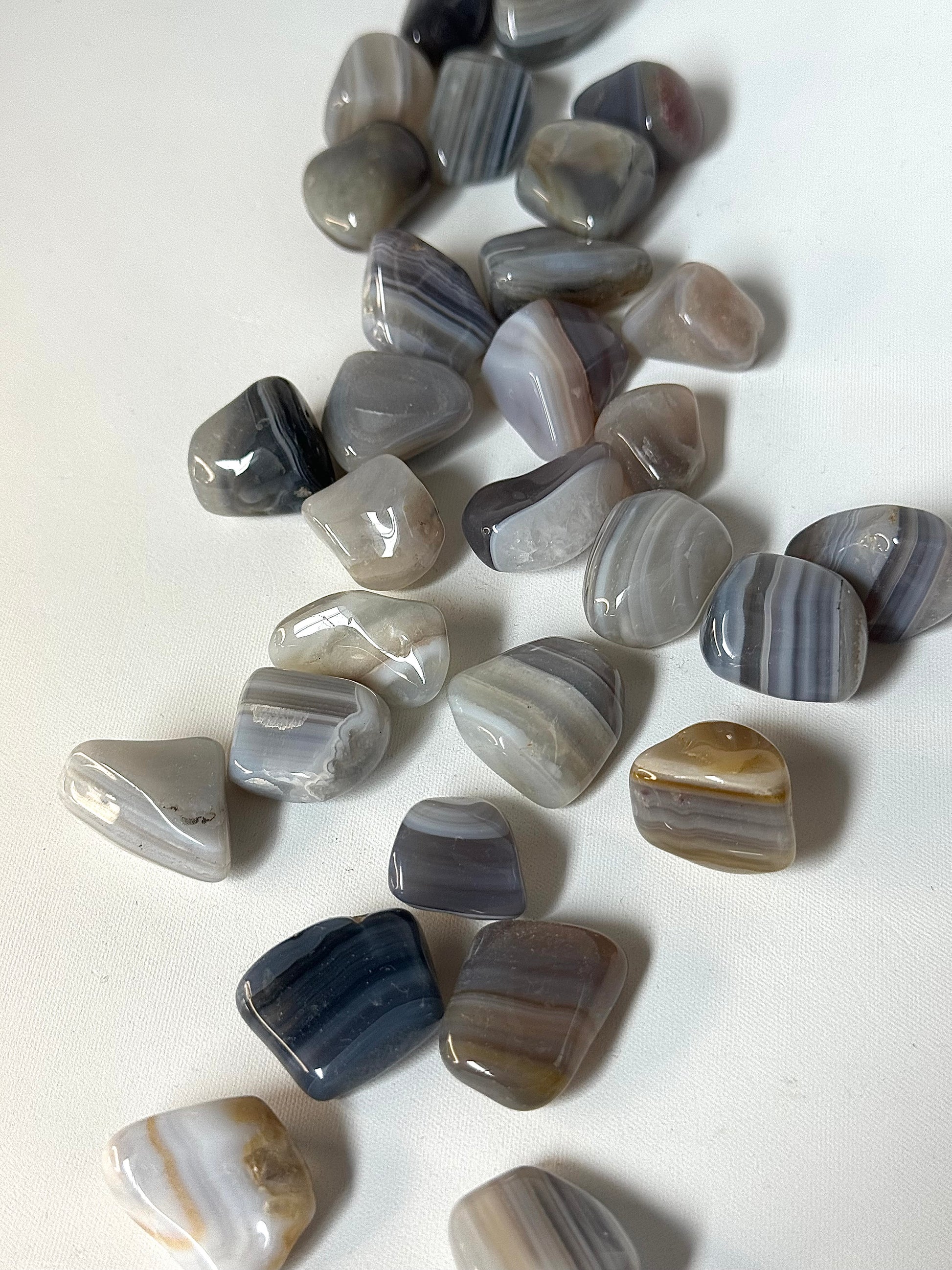 Polished Banded Agate Crystal Tumble Stones for grounding and peace, ideal for healing and spiritual wellness collections.