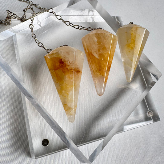 Golden Healer Pendulums - NZ Crystal Shop | Medium Pendulums featuring three faceted cone-shaped crystals on chains, ideal for energy healing.