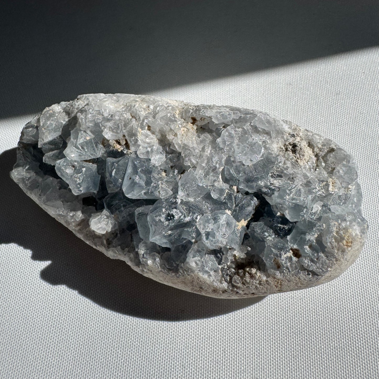 Celestite Crystal Druze Cluster #2 featuring translucent blue geode formations. Perfect for collectors seeking tranquility and clarity.