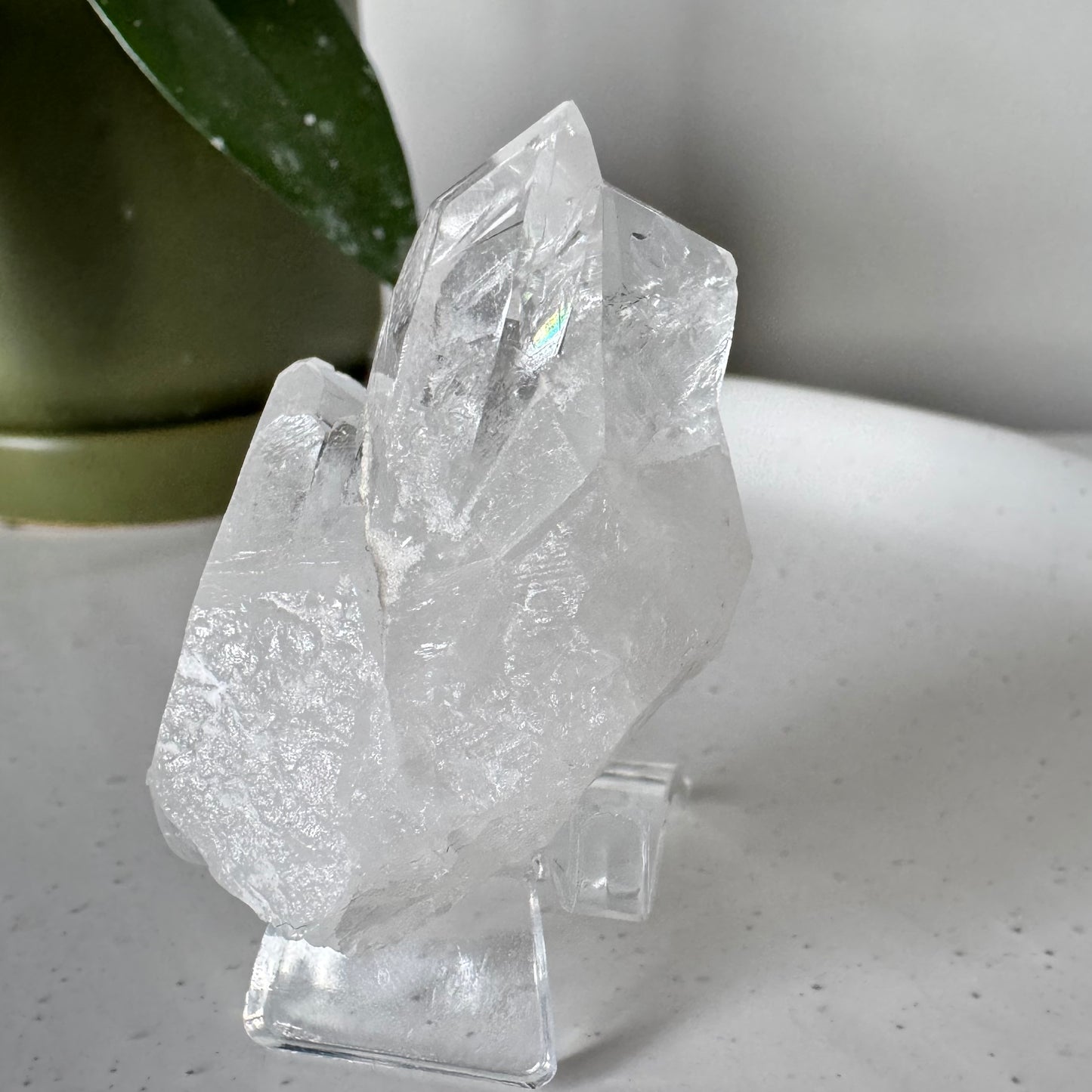 Quartz Cluster (Brazil) #3 from Bespoke Crystals Auckland displayed on a clear stand, showcasing natural clarity and raw crystal formations.