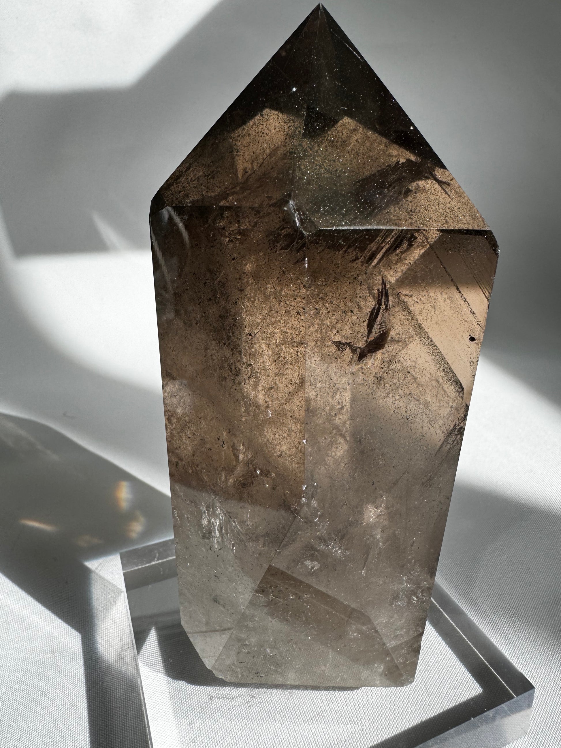 Natural Large Smokey Quartz Point with dark hues and protective energy, displayed on a clear base for arts and entertainment collectors.