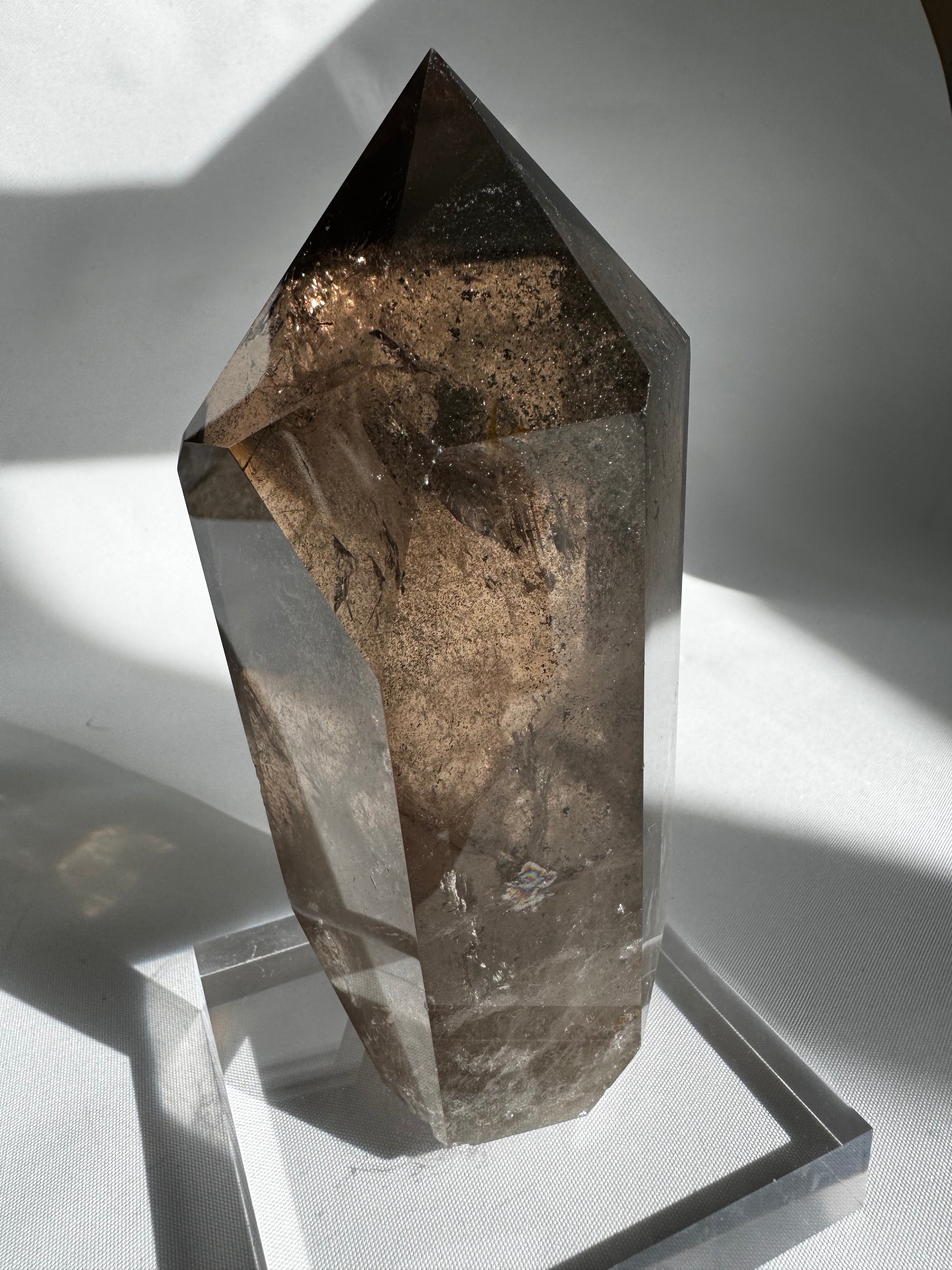 Polished Large Smokey Quartz Crystal Point featuring natural inclusions and clarity, perfect for collectors of bespoke grounding crystals.