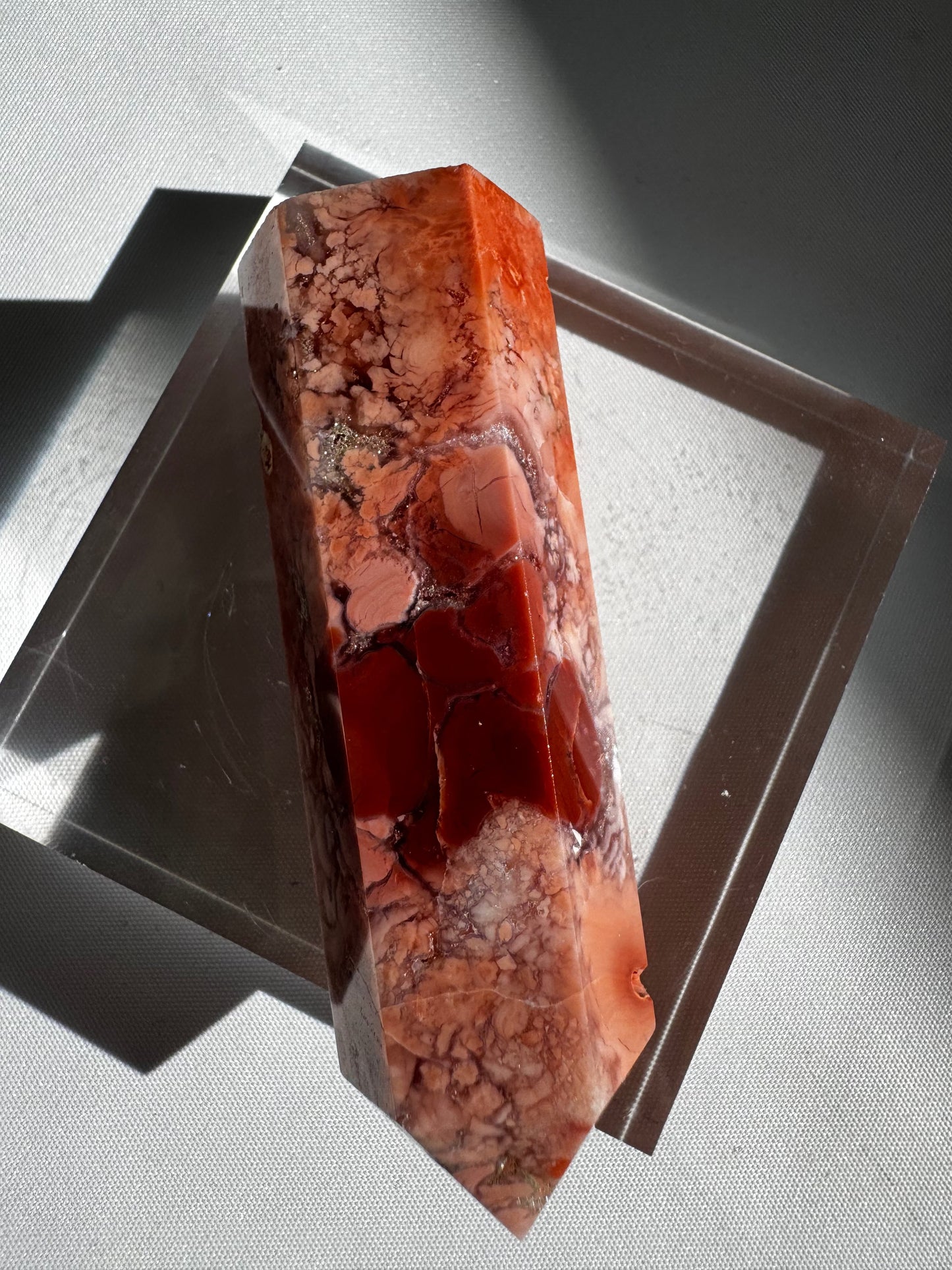Detailed view of Cotton Candy Agate Crystal Point #4 | Bespoke Crystals with vivid red and pink jasper segments, ideal for collectors.