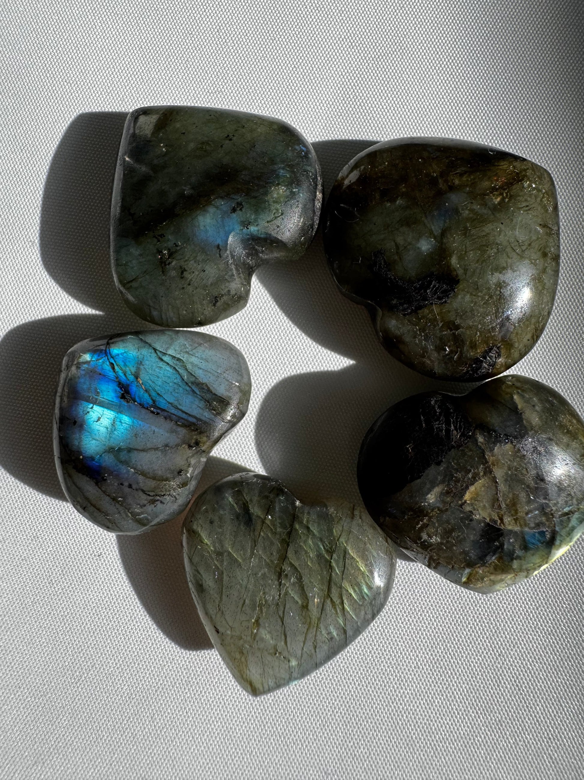 Group of Labradorite Crystal Mini Hearts arranged in a circle, highlighting their natural shimmer and collectible quality for crystal enthusiasts.
