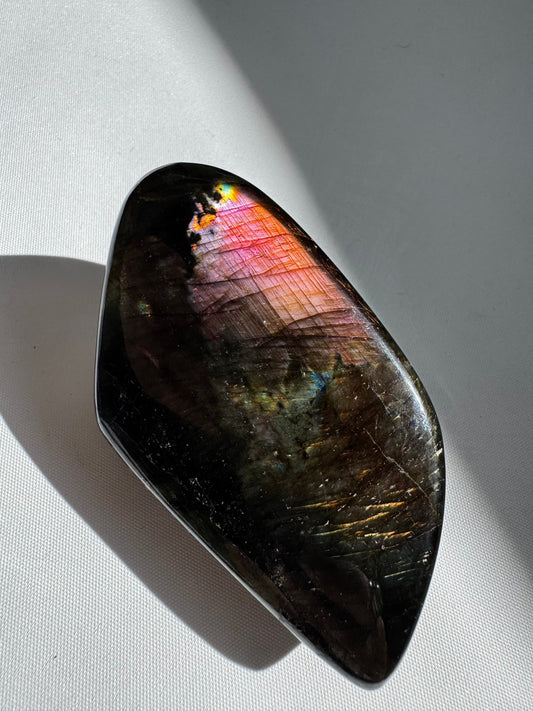 HQ Labradorite Crystal Freeform #L26 with vibrant pink and blue flash, polished surface, ideal for collectors and crystal healing enthusiasts.