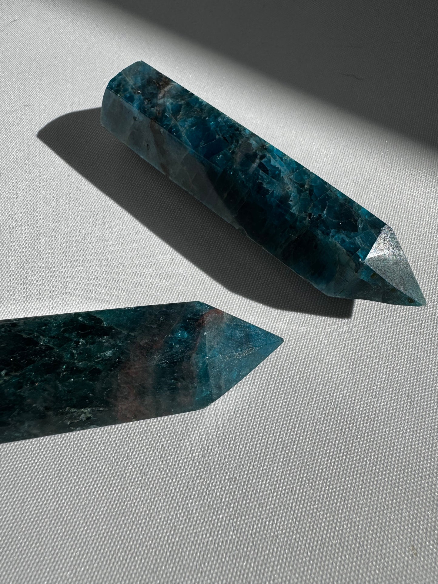 Two Blue Apatite Points showcasing rich blue tones and natural inclusions, perfect for growth, motivation, and communication energy work.