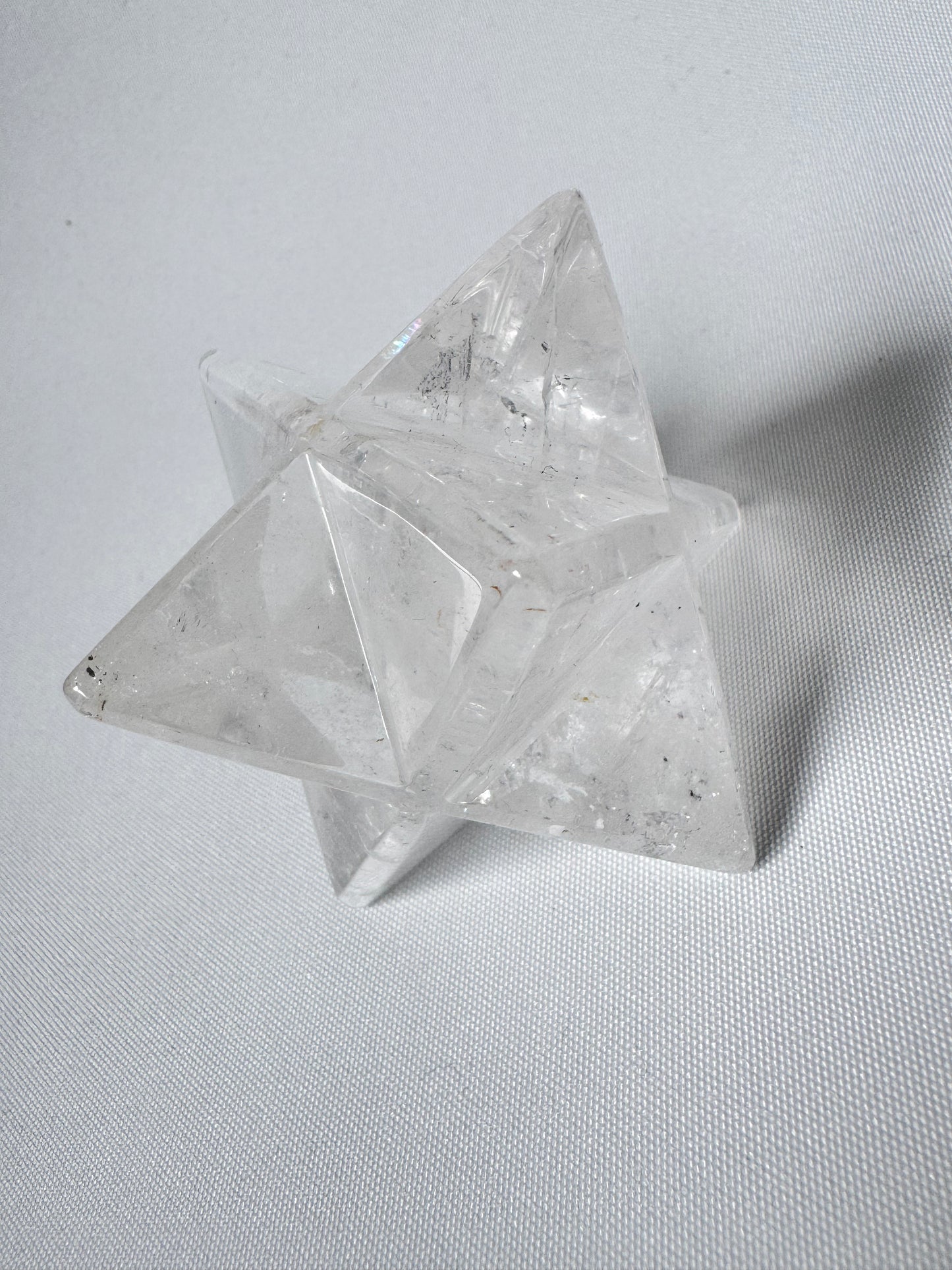 Single Quartz Merkaba Star with intricate geometric facets, radiating pure crystal light. Perfect as a spiritual holiday ornament or gift.
