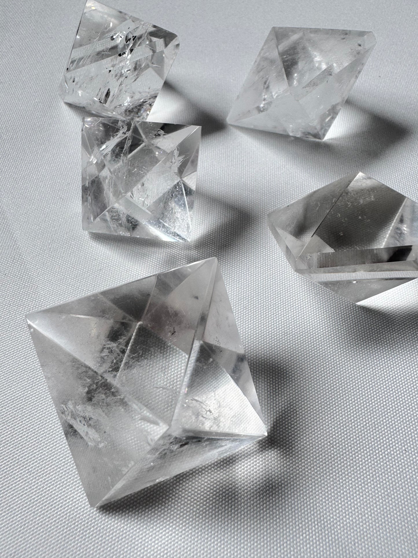 Set of five Lemurian Quartz Octahedrons on white background, ideal for energy focus and spiritual transformation toolkit.