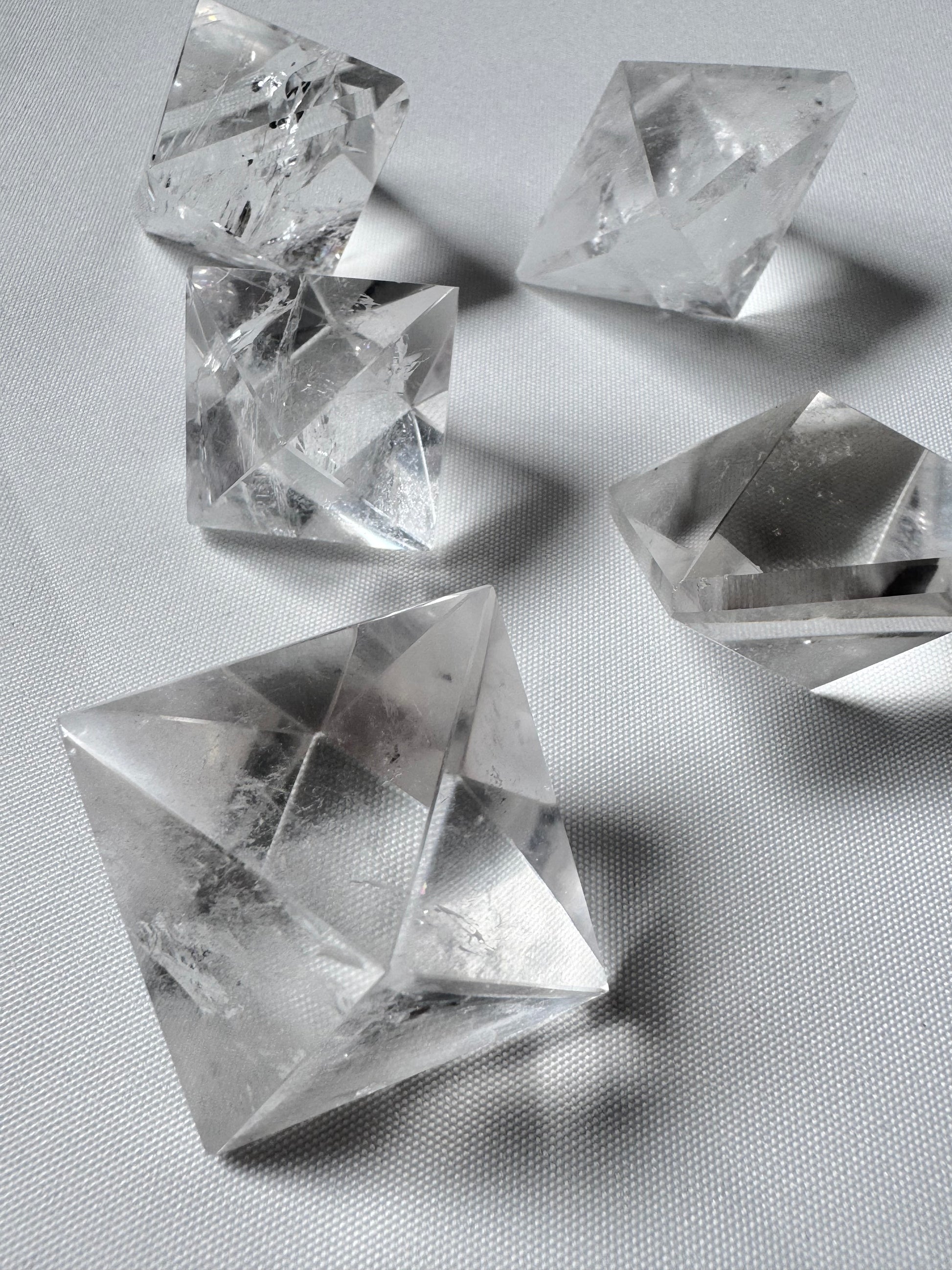 Set of five Lemurian Quartz Octahedrons on white background, ideal for energy focus and spiritual transformation toolkit.