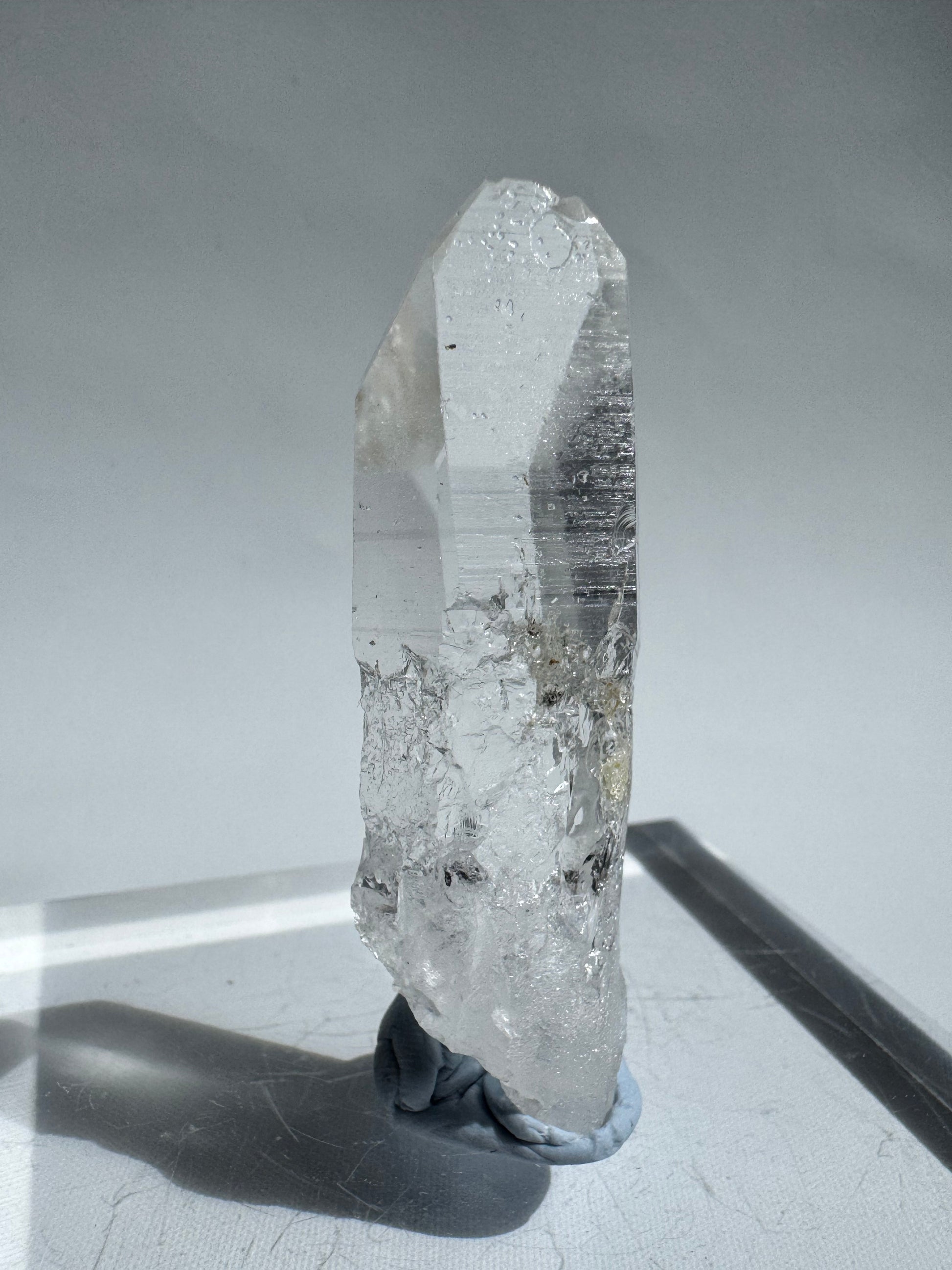 High-vibration Silver Light Crystal Lemurian Seed Point with visible inclusions and polished termination, used for consciousness elevation and healing.