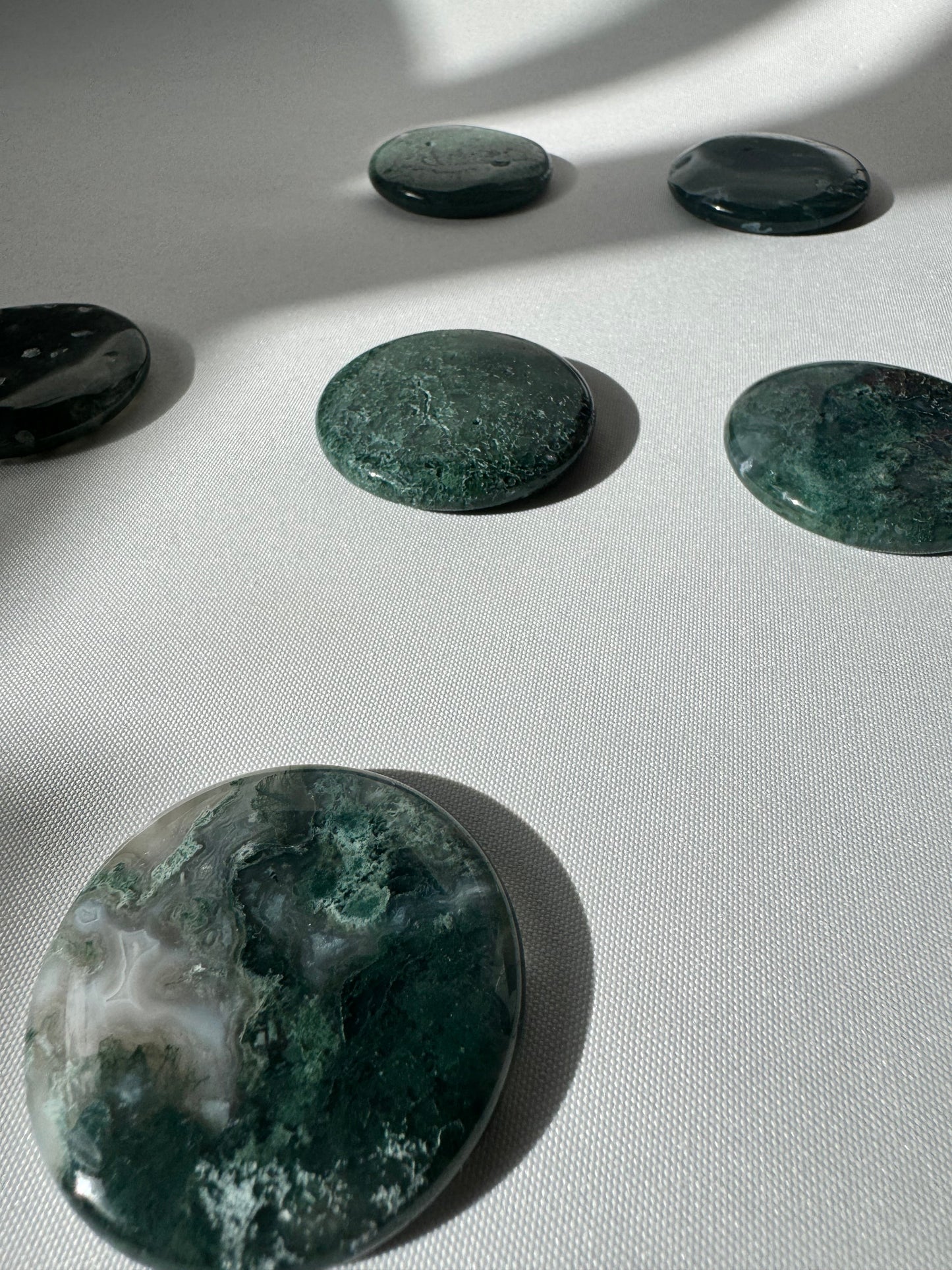 Set of Moss Agate Crystal Coins | Bespoke Crystals, showcasing their rich green hues and smooth, flat design.
