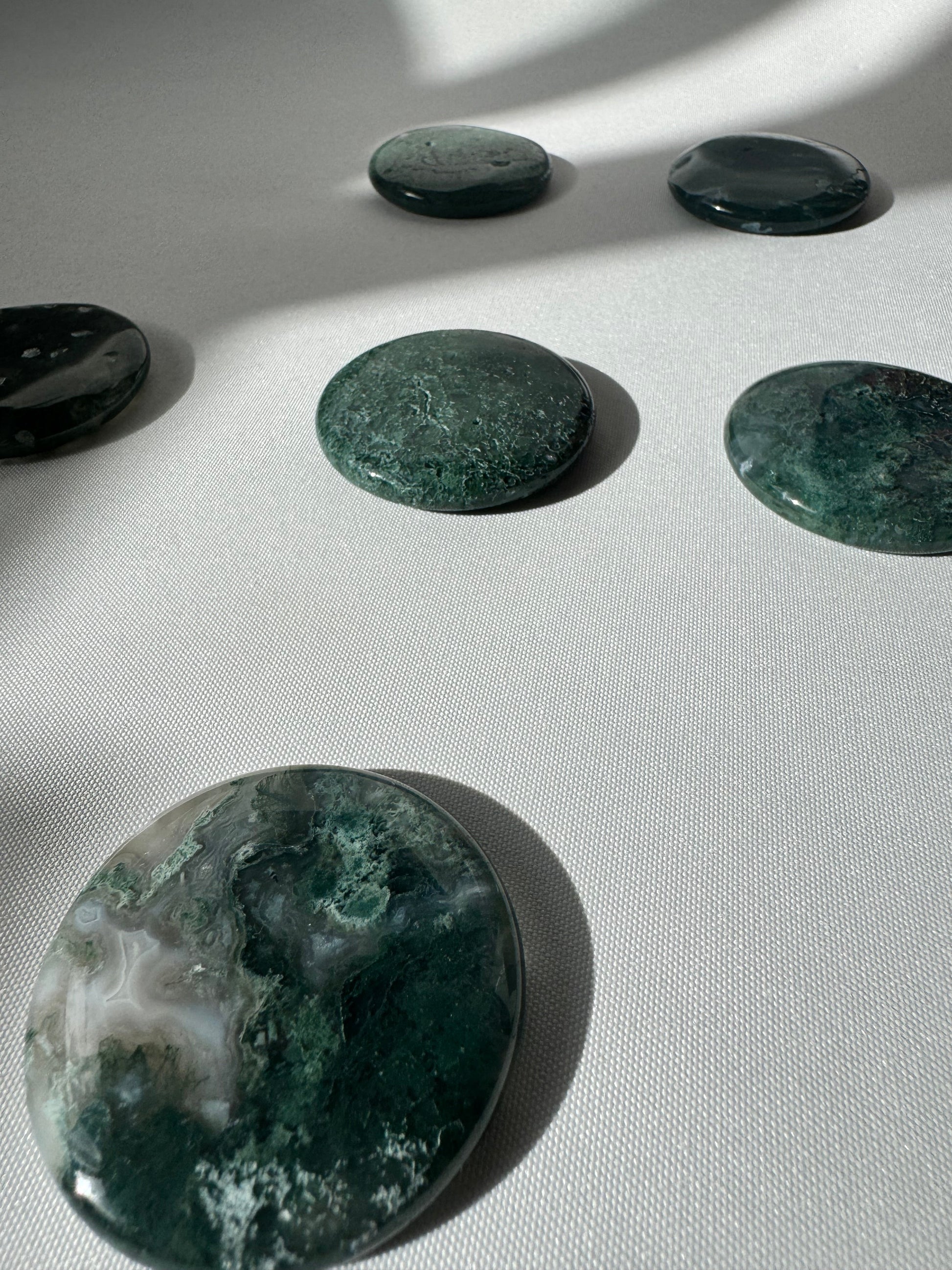 Set of Moss Agate Crystal Coins | Bespoke Crystals, showcasing their rich green hues and smooth, flat design.