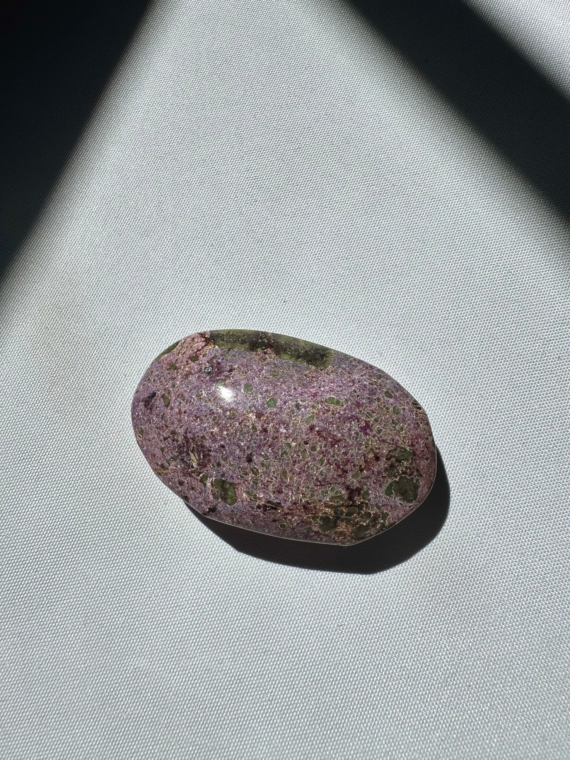 Smooth Atlantisite Crystal Palm Stone with fine-grained purple and green texture, ideal for collectors of rare healing stones.