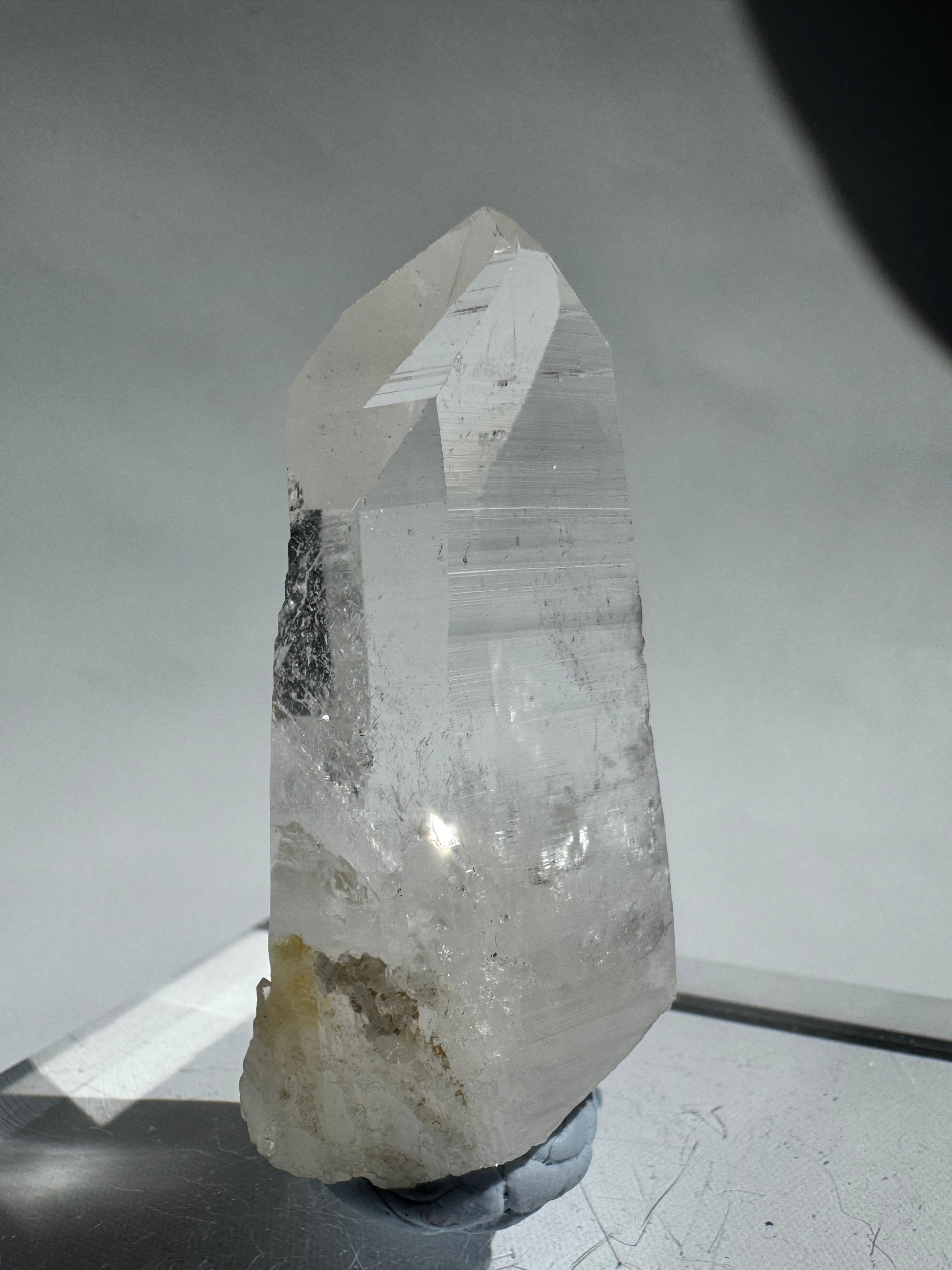 Lemurian Seed Point - Silver Light Crystal showcasing a polished point and raw base, used for intuition and energetic purification.