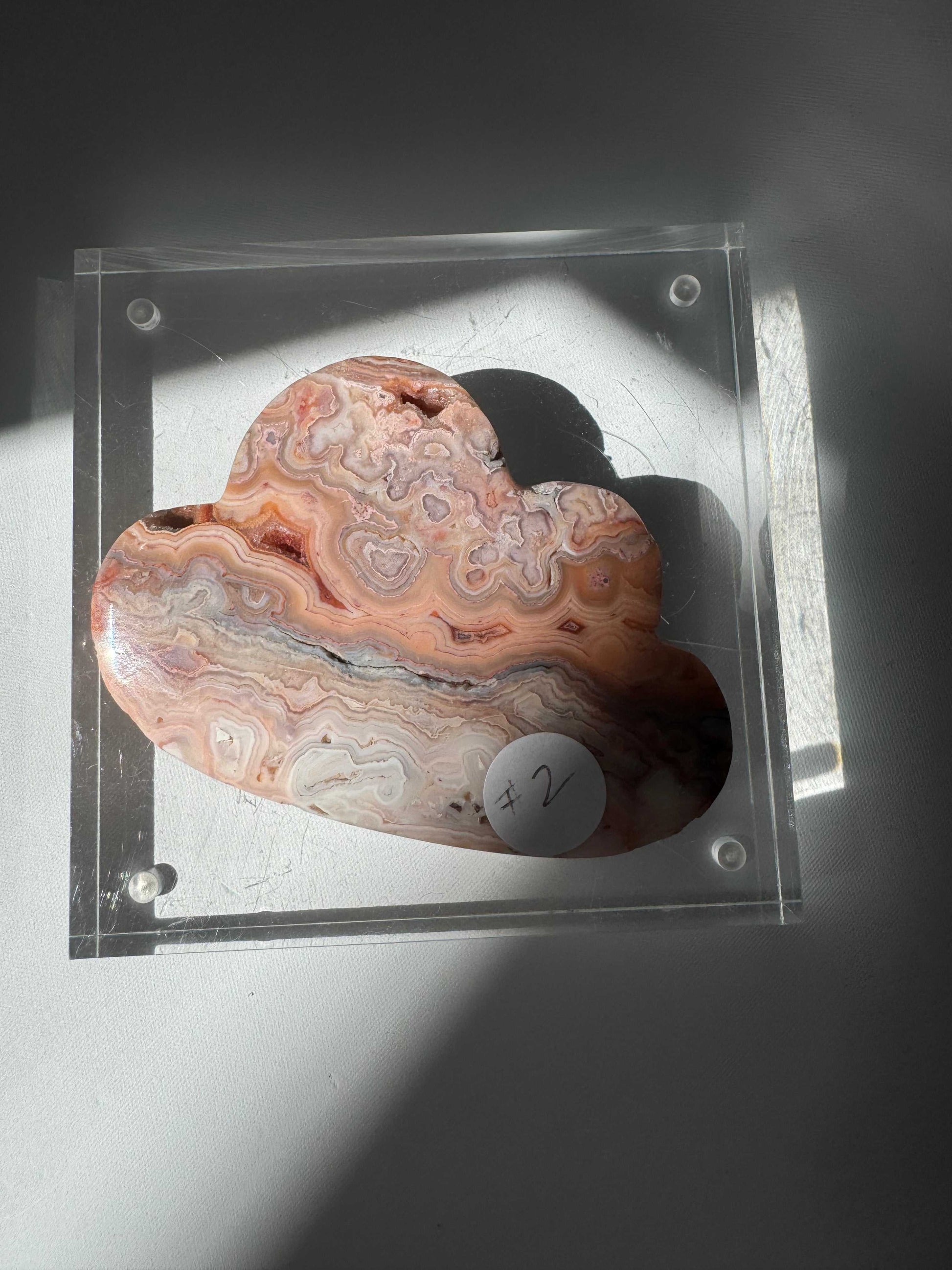 Pink Lace Agate Crystal Cloud #2 labeled with a sticker, highlighting its unique hand-carved form and calming pastel hues. A rare collectible for crystal enthusiasts | Healing Crystals New Zealand