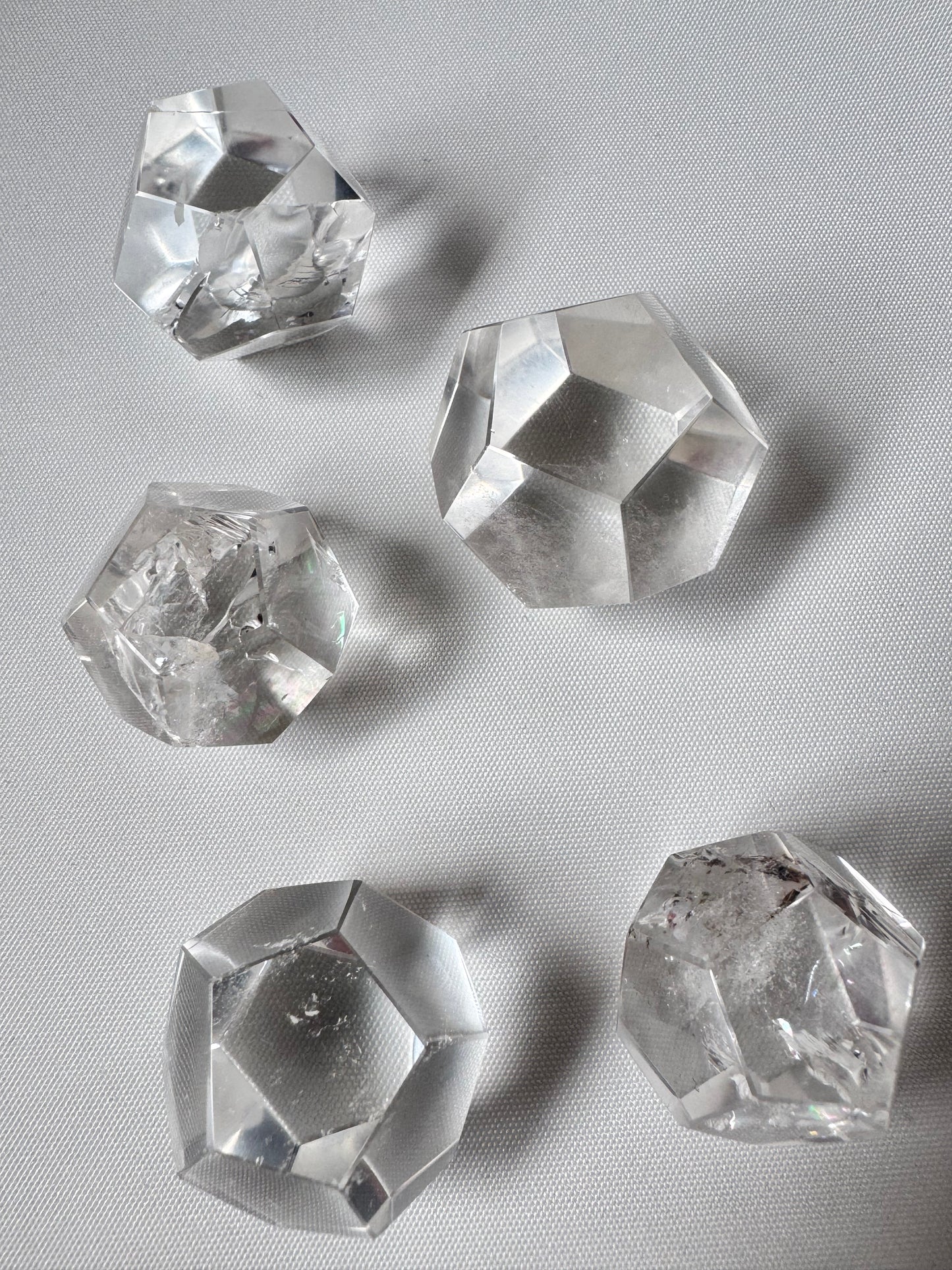 Lemurian Crystal Dodecahedron Set featuring five polished quartz shapes for meditation and energy work, displayed on a white surface.