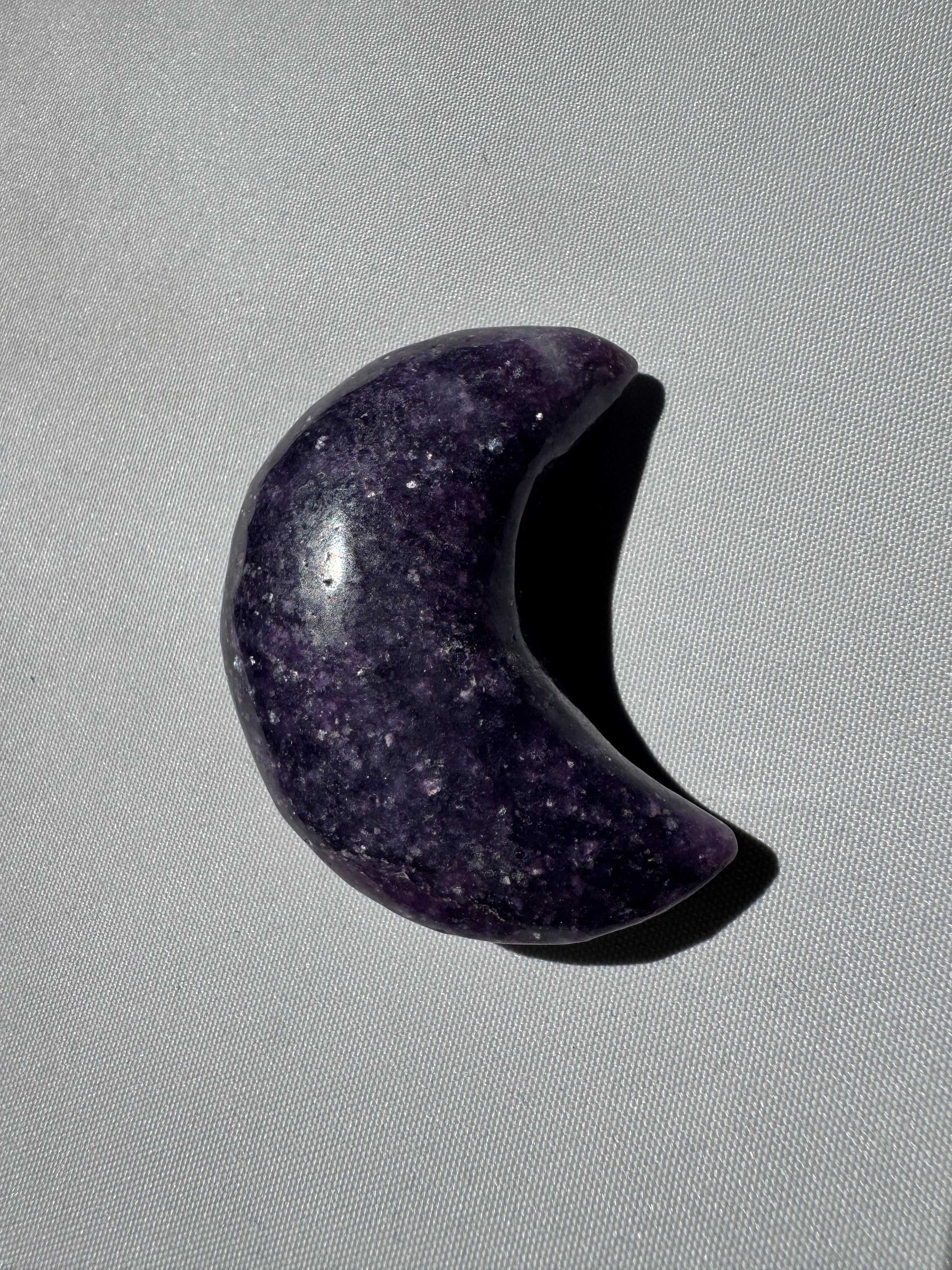 Single Lepidolite Crystal Moon in deep purple hue, polished and crescent-shaped. A bespoke crystal for calming energy and sacred spaces.