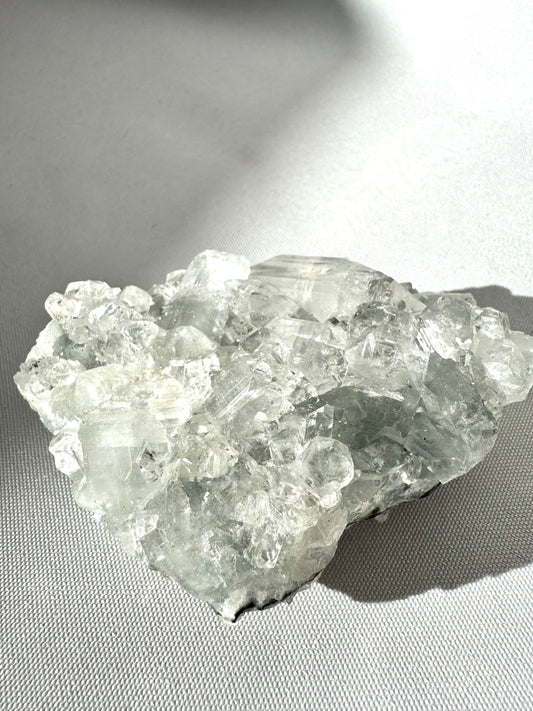 Apophyllite Crystal Cluster #3 featuring clear, pyramid-like formations with a radiant shine, ideal for collectors of crystals.