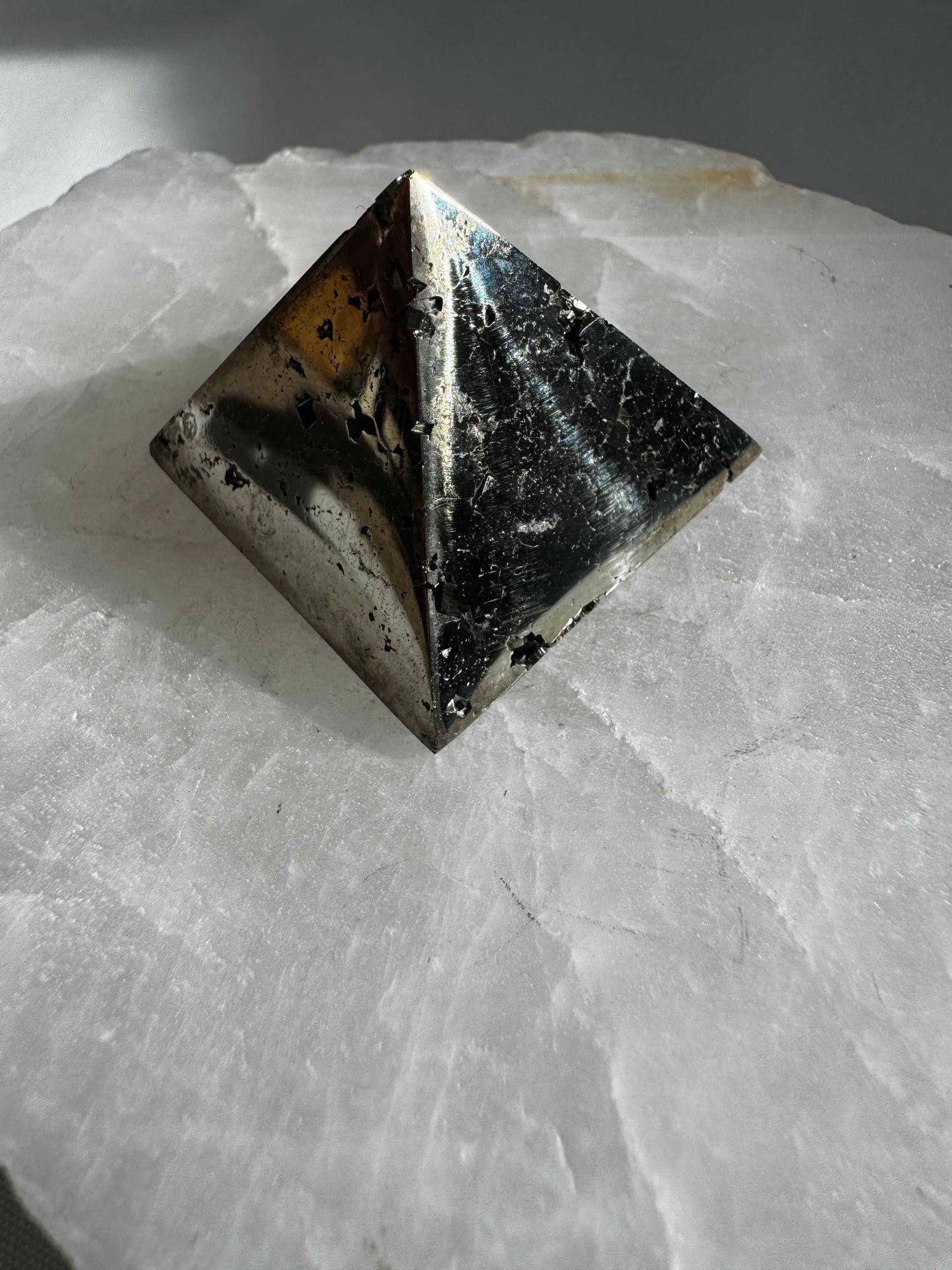 Shiny Pyrite Pyramid #14 featuring natural textures and reflective surfaces, ideal for boosting confidence and grounding energy in spiritual spaces.