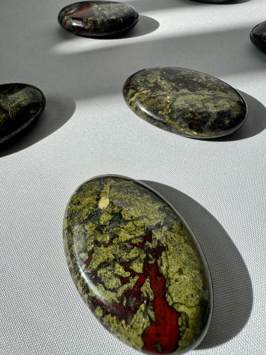 Dragon Stone Crystal Palm Stone with vivid red and green hues, polished for grounding and vitality. Ideal for collectors of bespoke crystals.