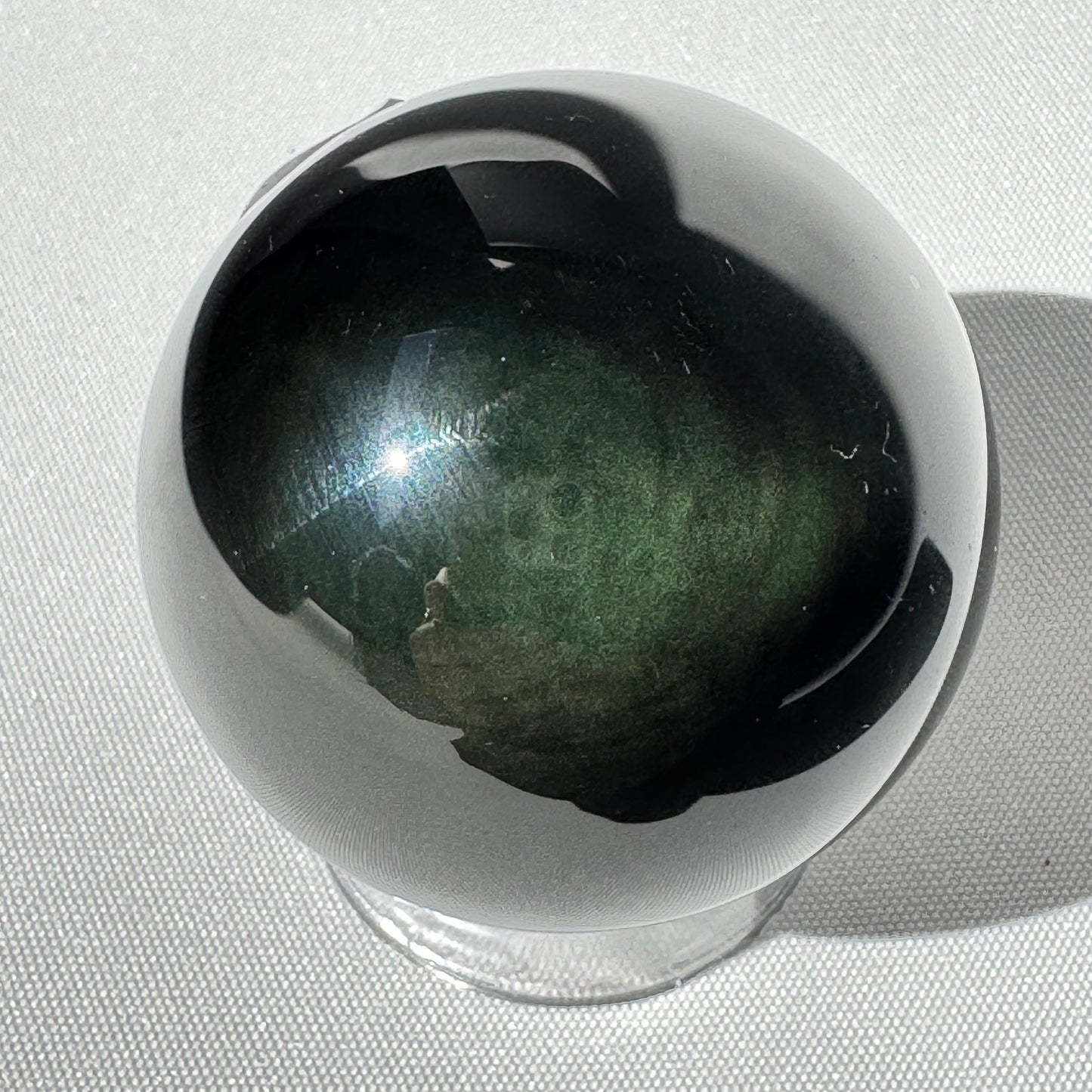 Rainbow Obsidian Sphere - Emotional Growth Crystal with green and black iridescence. Ideal for healing, protection, and meditation rituals.