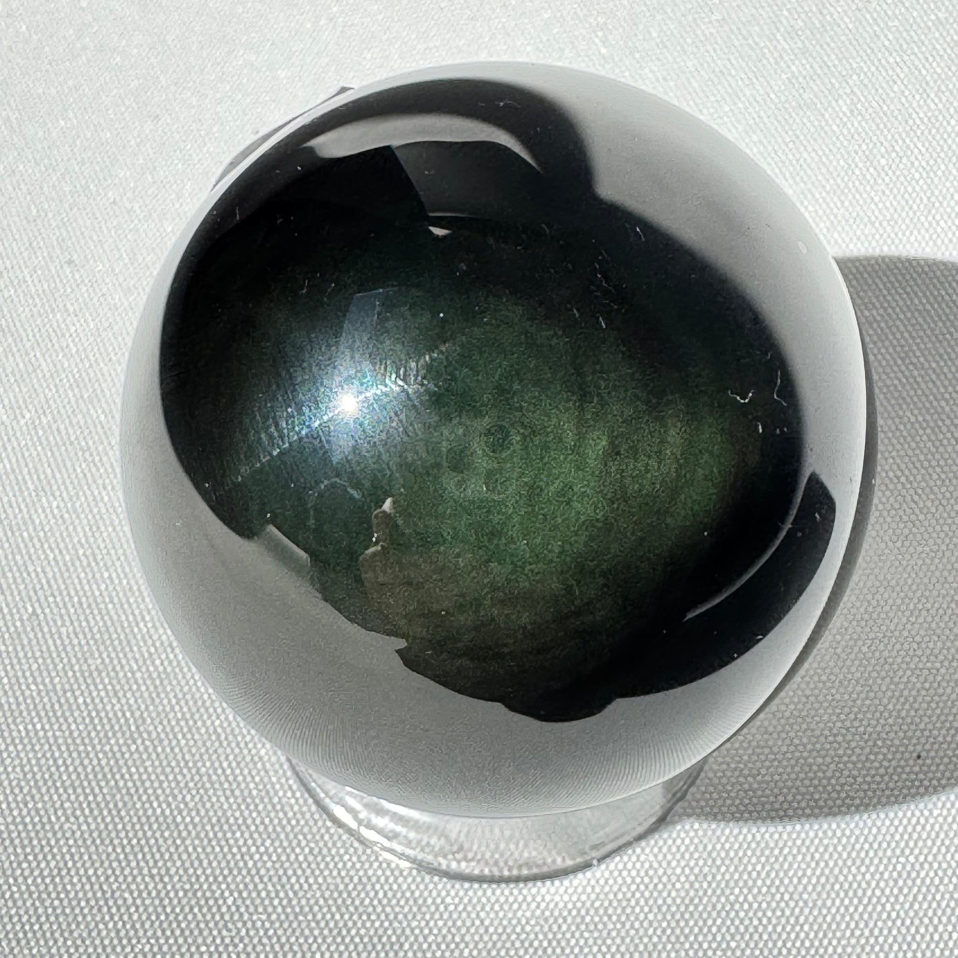 Rainbow Obsidian Sphere - Emotional Growth Crystal with green and black iridescence. Ideal for healing, protection, and meditation rituals.
