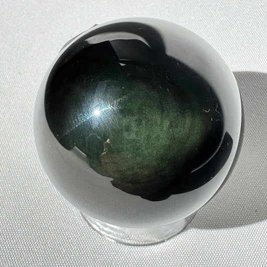 Rainbow Obsidian Sphere - Emotional Growth Crystal with green and black iridescence. Ideal for healing, protection, and meditation rituals.