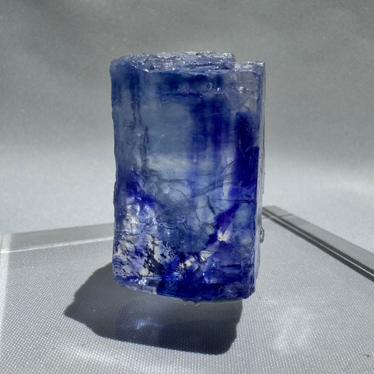 Tall Blue Halite crystal with layered blue and white striations, a rare collectible mineral for enthusiasts and energy workers.