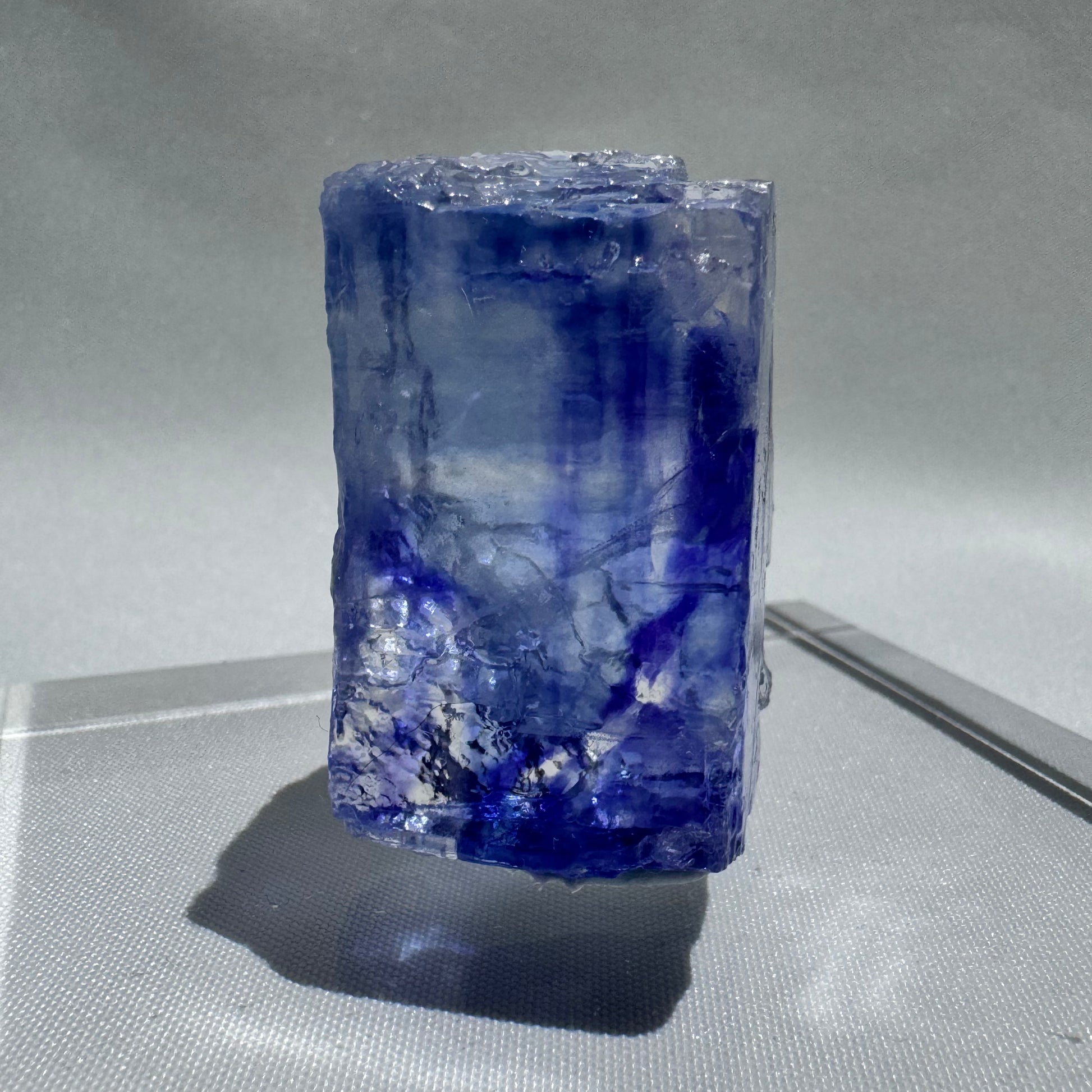 Tall Blue Halite crystal with layered blue and white striations, a rare collectible mineral for enthusiasts and energy workers.