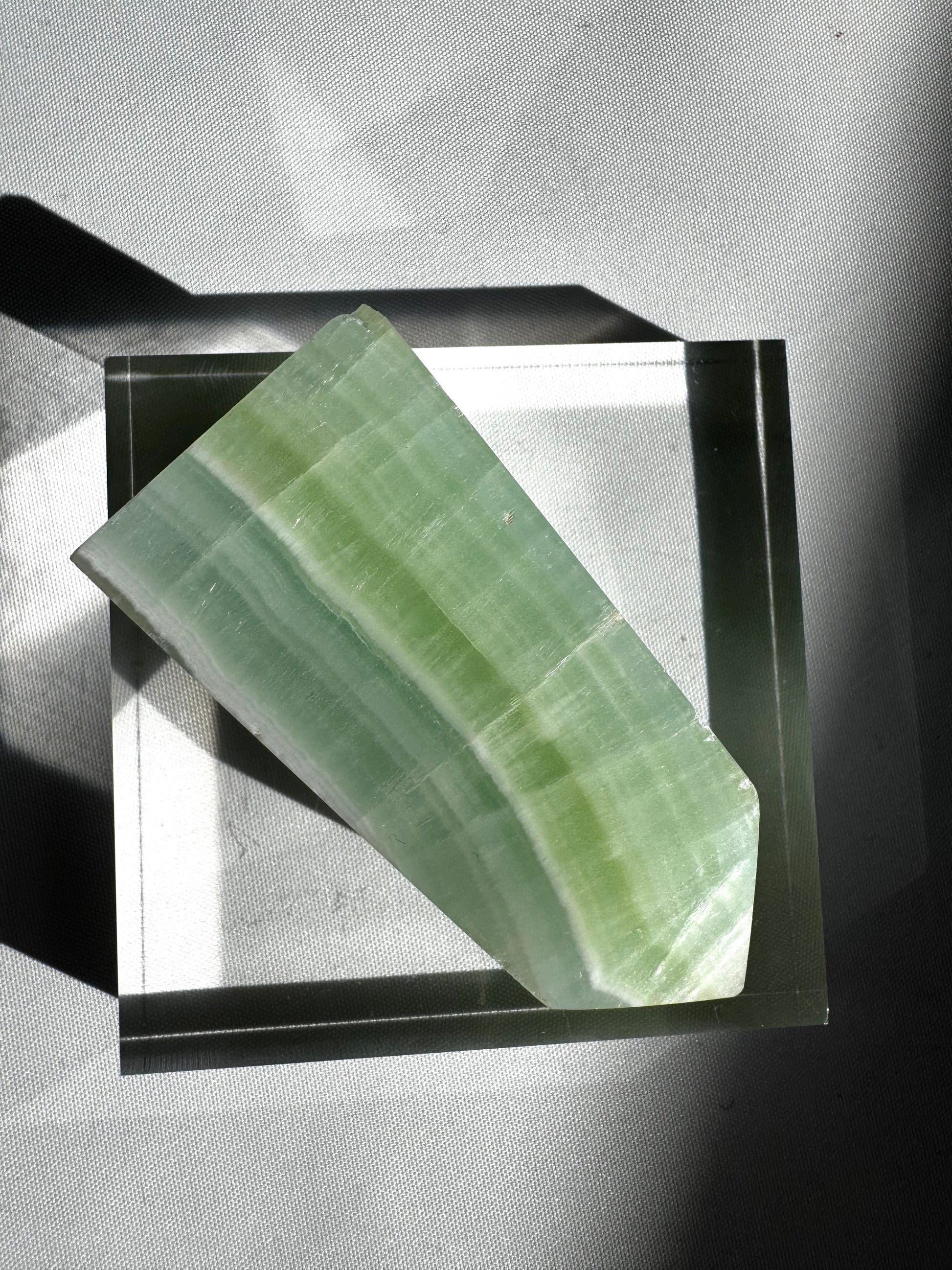 Angled view of Pistachio Calcite Mini Tower #3 showing layered green and white patterns, perfect for crystal collectors and empaths.