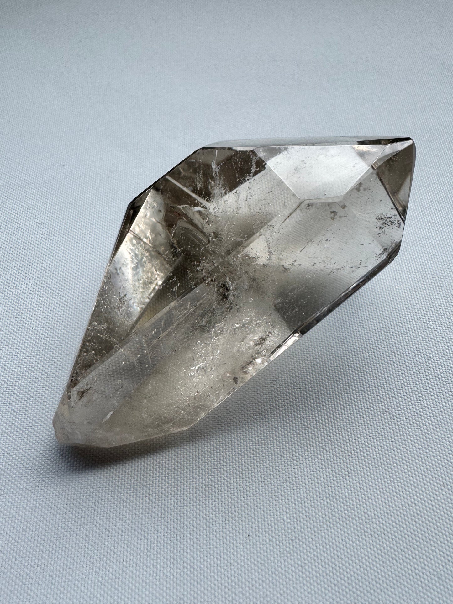 Hand holding smoky quartz freeform crystal with natural clarity and internal inclusions | Buy crystals NZ