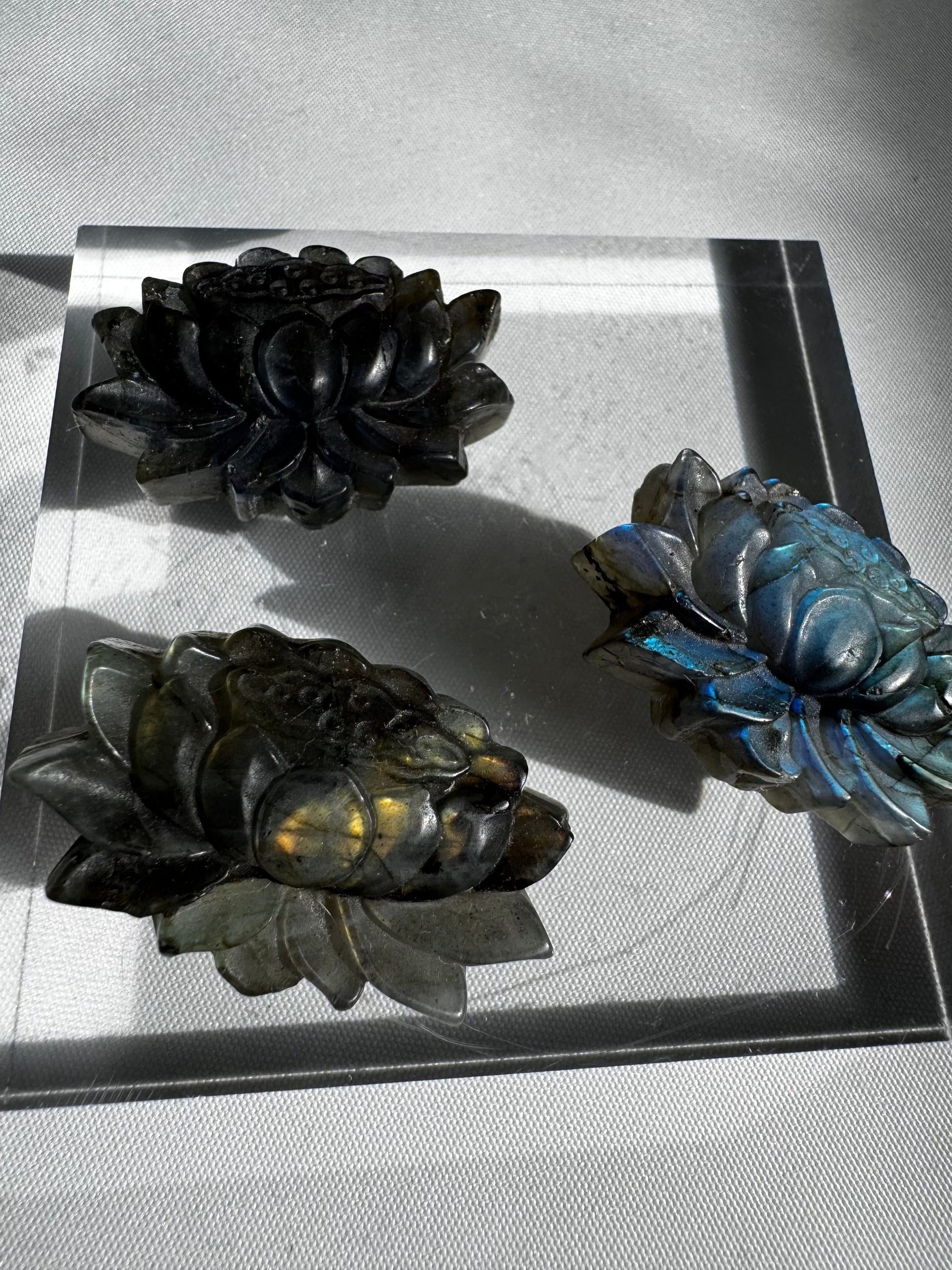 Labradorite Crystal Lotus Carving | Bespoke Crystals arranged on a clear acrylic stand, highlighting the shimmering blue and gold labradorite tones.