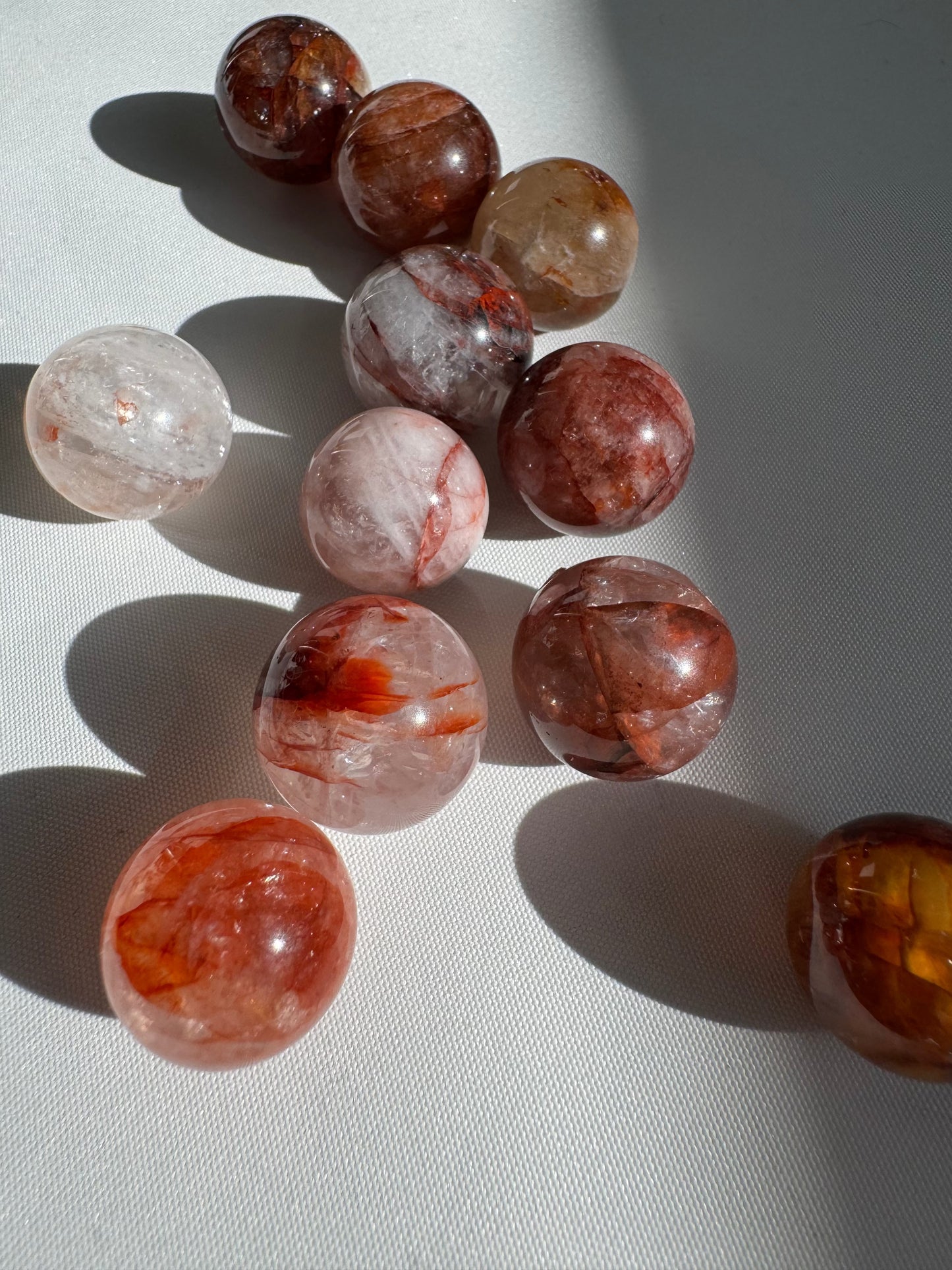 Bespoke Mini Fire Quartz Crystal Spheres featuring natural rainbows and fiery hues, perfect for collectors and crystal healing enthusiasts.
